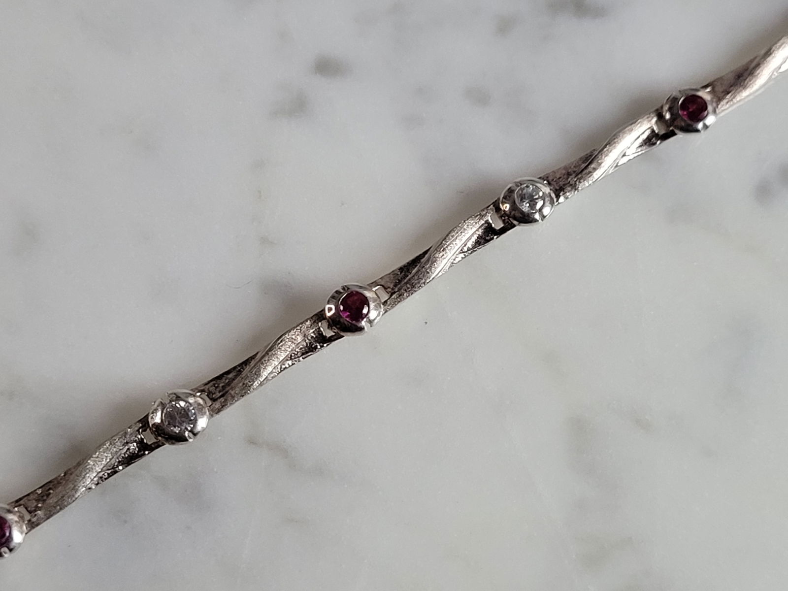 Womens Vintage Estate Sterling Silver Garnet CZ Bracelet: A WOMENS VINTAGE ESTATE STERLING SILVER GARNET & CZ BRACELET. BRACELET MEASURES 7 3/4" LONG BY 1/8" WIDE AND WEIGHS 7.2g. THIS WOULD MAKE A LOVELY GIFT FOR THAT SOMEONE SPECIAL. ANY QUESTIONS, PLEASE