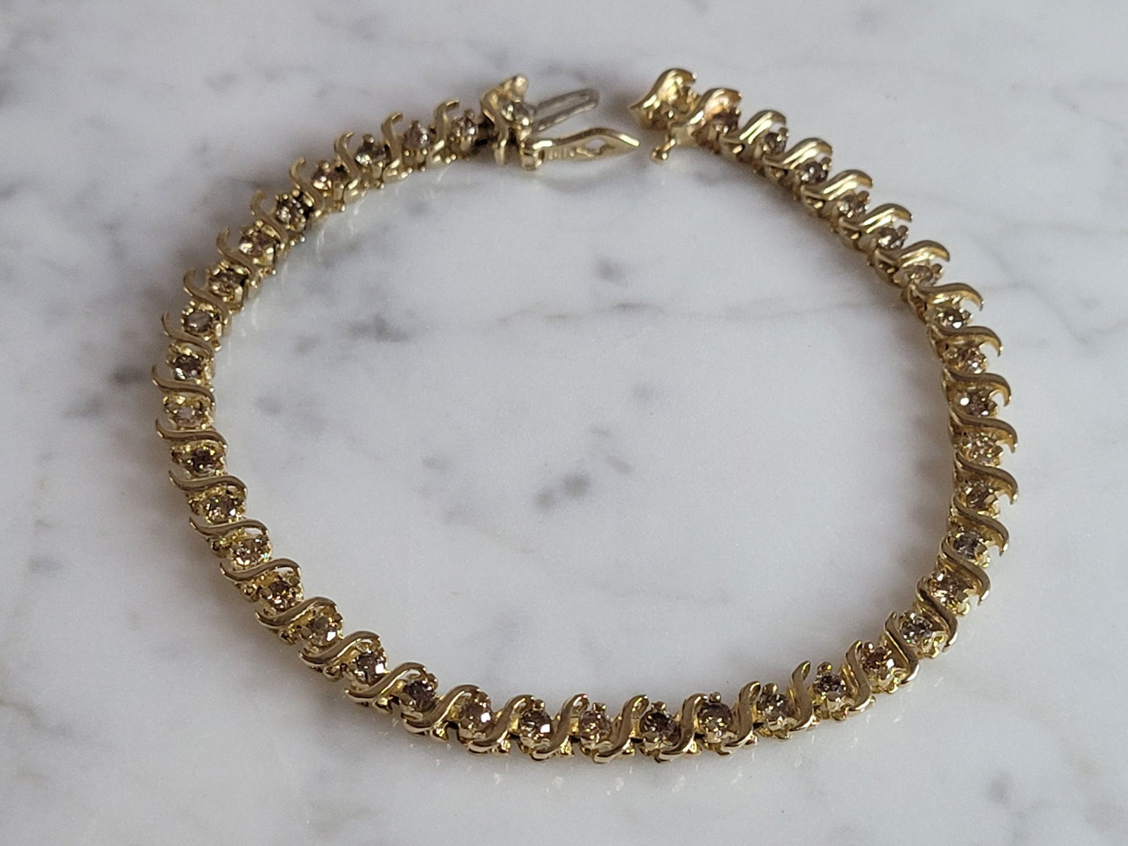 Womens Vintage Estate 14K Gold Diamond Tennis Bracelet w/ 2.0cts: A LOVELY WOMENS VINTAGE ESTATE 14K YELLOW GOLD TENNIS BRACELET WITH ABOUT 2.0cts OF DIAMONDS. THE BRACELET WEIGHS 12.4g AND MEASURES 7 1/2" LONG, BY 3/16" WIDE. MISSING A TINY DIAMOND AT ONE END. EASY
