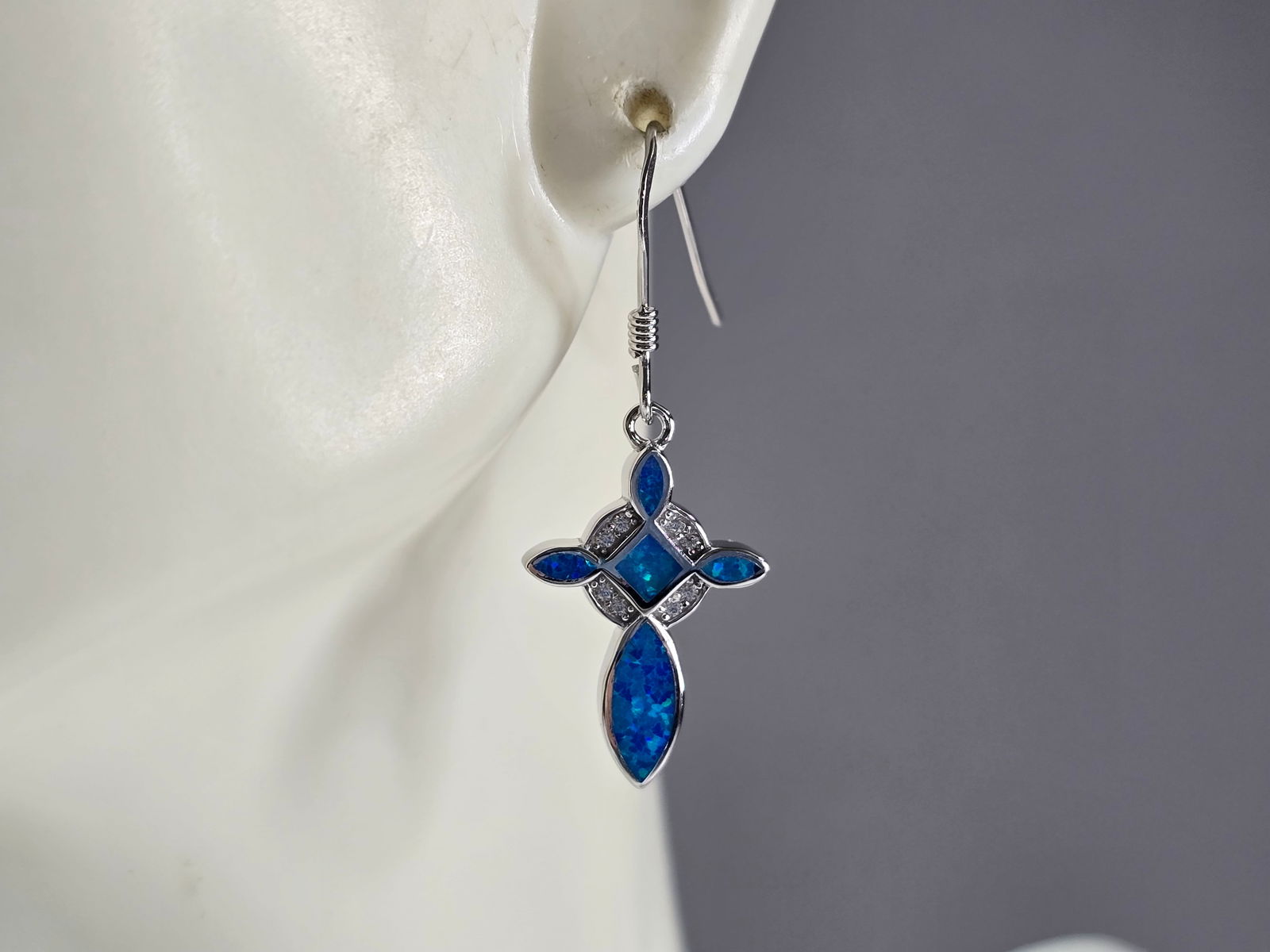 Womens Sterling Silver Blue Opal Cross Earrings: A PAIR OF WOMENS STERLING SILVER BLUE OPAL COLORED CROSS EARRINGS THAT WEIGH 3.3g AND MEASURES 1 1/4" LONG BY 1/2" WIDE. NOT SURE IF STONES ARE NATURAL OR MAN MADE. ANY QUESTIONS, PLEASE DO NOT HESITA