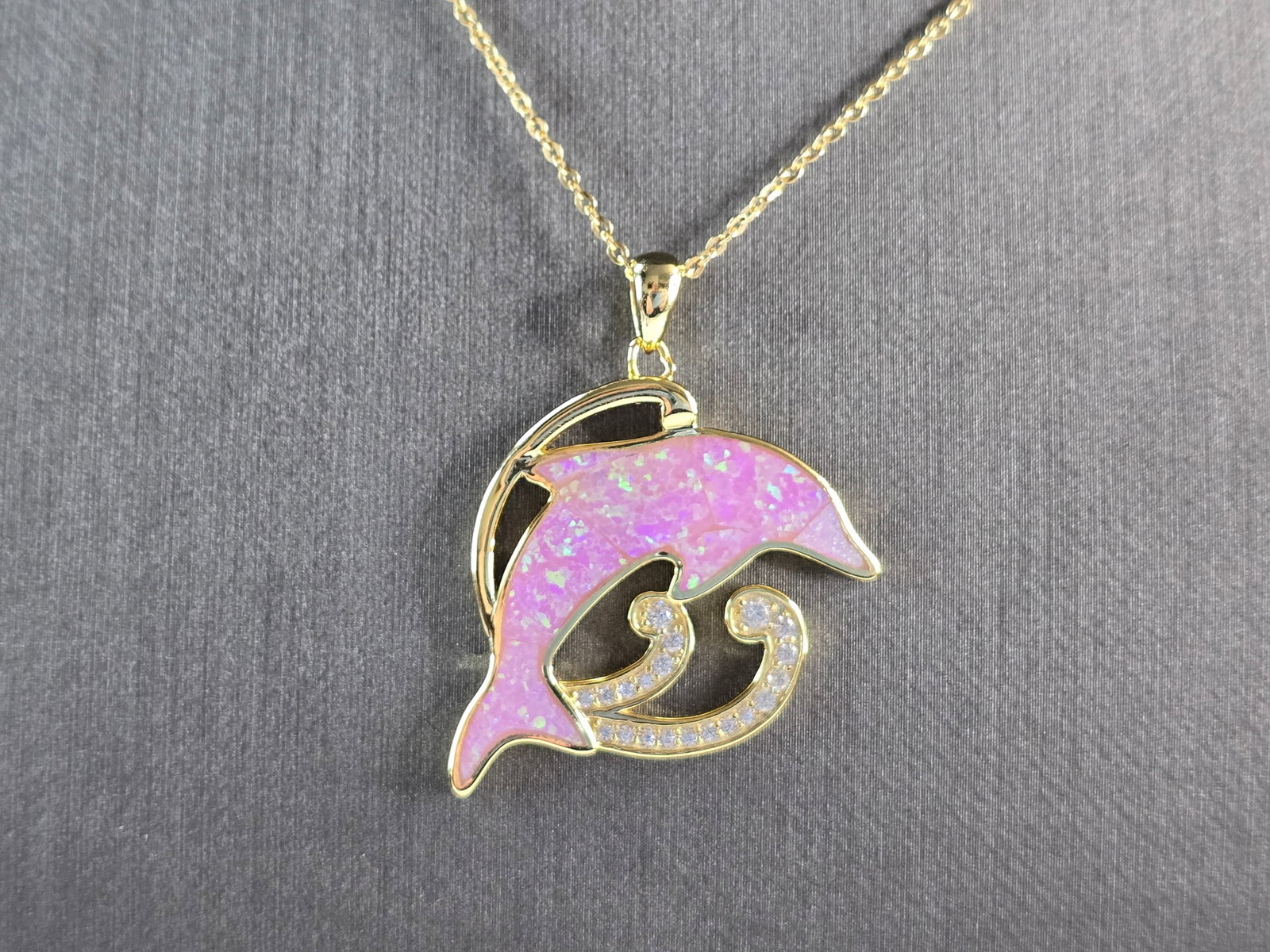 Womens Sterling Silver Gold Tone Pink Opal Dolphin Pendant Necklace: A WOMENS STERLING SILVER GOLD TONE PINK OPAL DOLPHIN PENDANT WITH NECKLACE. THE PENDANT WITH NECKLACE WEIGHS 8.0g. PENDANT MEASURES 1 3/8" LONG BY 1" WIDE, AND THE NECKLACE MEASURES 18" LONG, ADJUSTAB