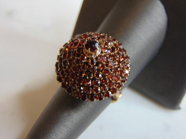 Womens Vintage Estate 10K Yellow Gold Garnet Cocktail Ring: A WOMENS VINTAGE ESTATE 10K YELLOW GOLD GARNET COCKTAIL RING . THE TOTAL WEIGHT IS 7.9g. THE RING SIZE IS A 7.25. RING MEASURES 7/8" WIDE AND STANDS ABOUT 3/4" TALL ON THE FINGER. RING IS MISSING TWO