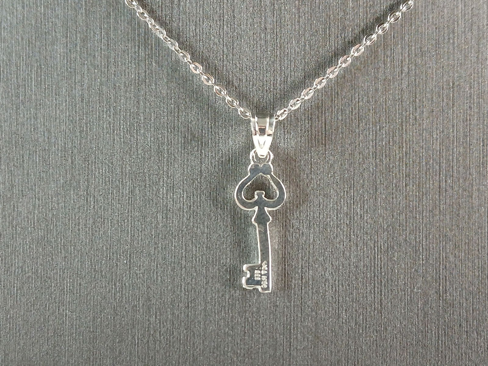 Womens Sterling Silver Key to My Heart Pendant Necklace: A WOMENS STERLING SILVER KEY TO MY HEART PENDANT WITH NECKLACE. THE TOTAL WEIGHT IS 2.1g. THE NECKLACE MEASURES 18" LONG, ADJUSTABLE TO 16" LONG. THE PENDANT MEASURES 7/8" LONG BY 1/4" WIDE. MAKES A G