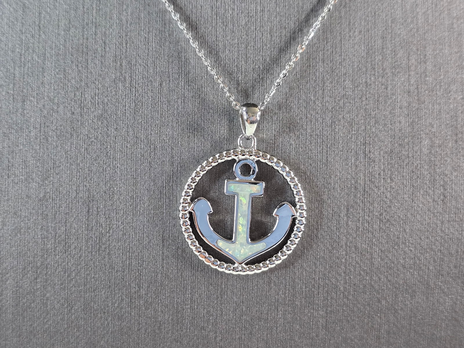 Womens Sterling Silver Opal Maritime Anchor Pendant Necklace: A WOMENS STERLING SILVER OPAL ANCHOR PENDANT WITH NECKLACE. THE PENDANT AND NECKLACE WEIGHS 6.3g. THE PENDANT MEASURES 1 1/4" LONG BY 1" WIDE. THE NECKLACE MEASURES 18" LONG AND IS ADJUSTABLE TO 16".