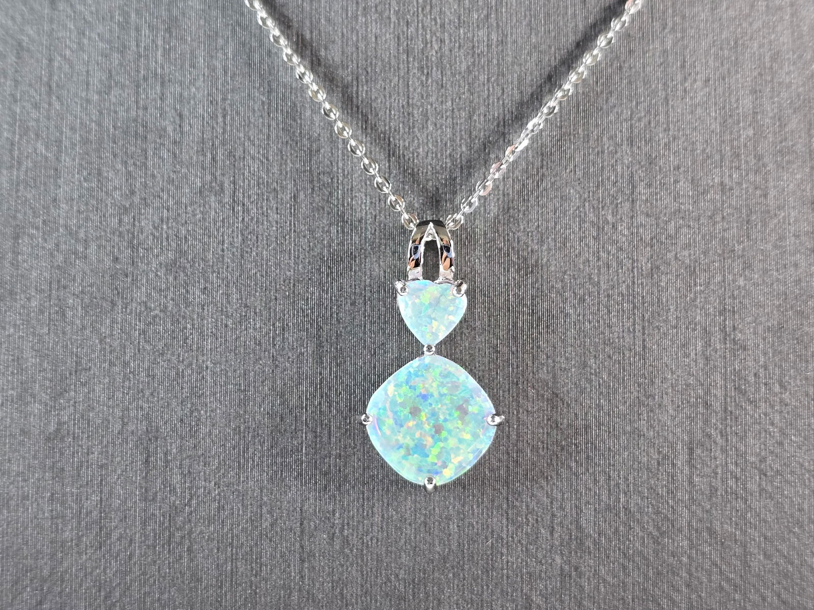 Womens Sterling Silver Opal Modernist Heart Pendant Necklace: A WOMENS STERLING SILVER OPAL MODERNIST HEART PENDANT. THE PENDANT WITH NECKLACE WEIGHS 3.0g. THE PENDANT MEASURES 7/8" LONG BY 1/2" WIDE. THE NECKLACE MEASURES 18" LONG AND IS ADJUSTABLE TO 16" LONG.