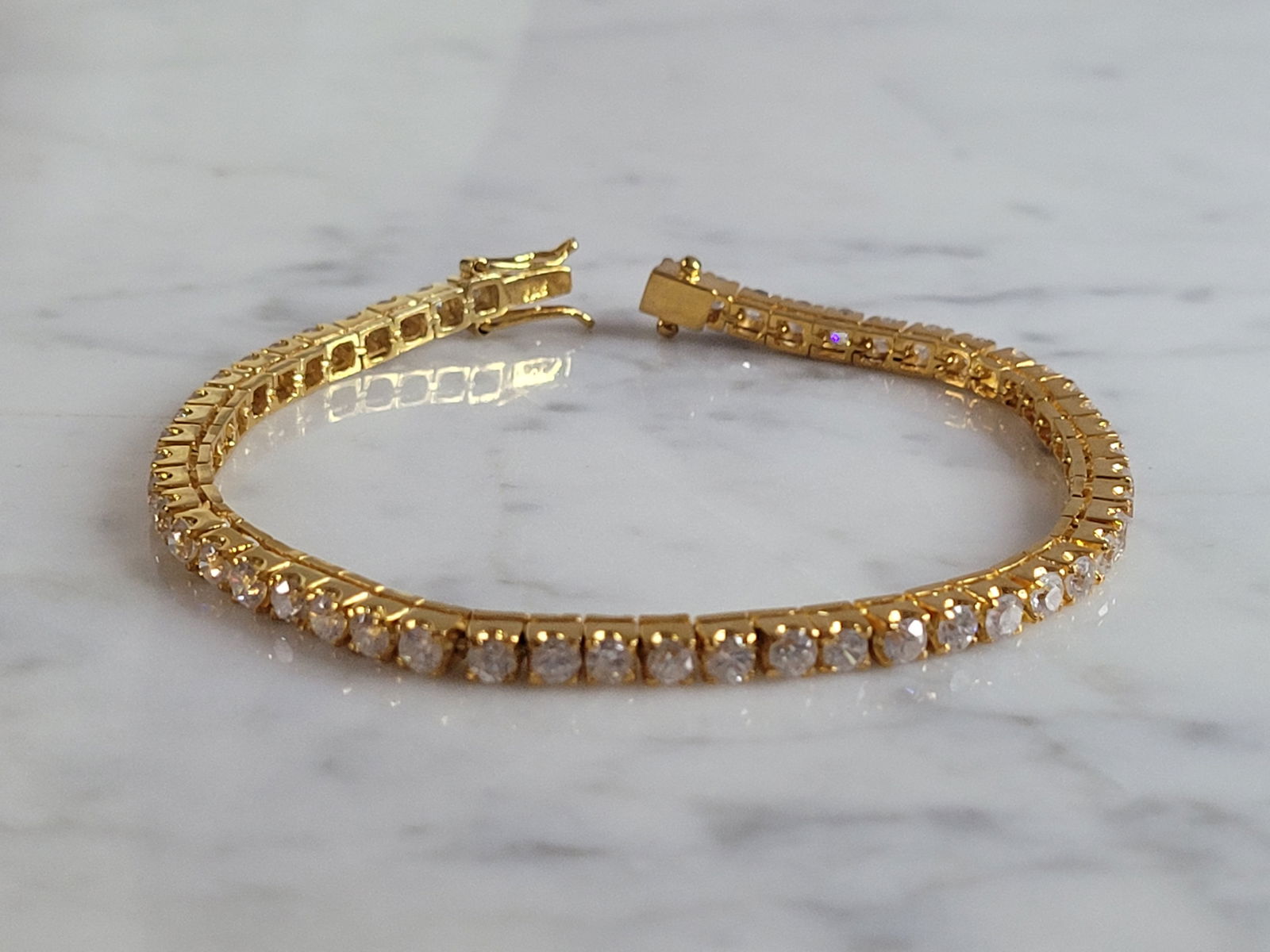 Vintage Sterling Silver Gold Tone Tennis Bracelet: FOR SALE IS THIS LOVELY VINTAGE ESTATE STERLING SILVER GOLD TONE WOMENS TENNIS BRACELET WITH CZ STONES. THE BRACELET MEASURES 7" LONG BY 1/8" WIDE, AND WEIGHS 12.5g. WOULD MAKE A GREAT GIFT FOR THAT S