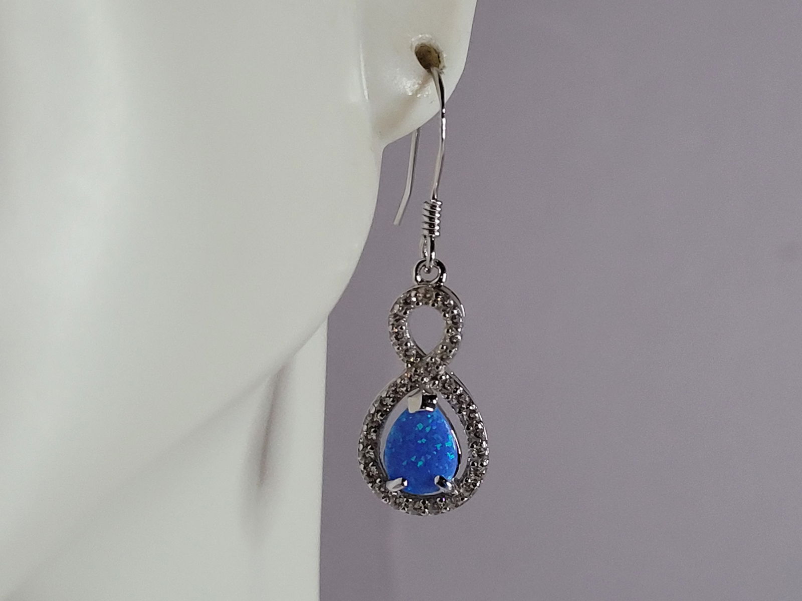 Womens Sterling Silver Modernist Blue Opal Earrings: A PAIR OF WOMENS STERLING SILVER MODERNIST BLUE OPAL COLORED EARRINGS THAT WEIGH 2.8g AND MEASURES 1 1/4" LONG BY 3/8" WIDE. NOT SURE IF STONES ARE REAL OR MAN MADE. ANY QUESTIONS, PLEASE DO NOT HESIT