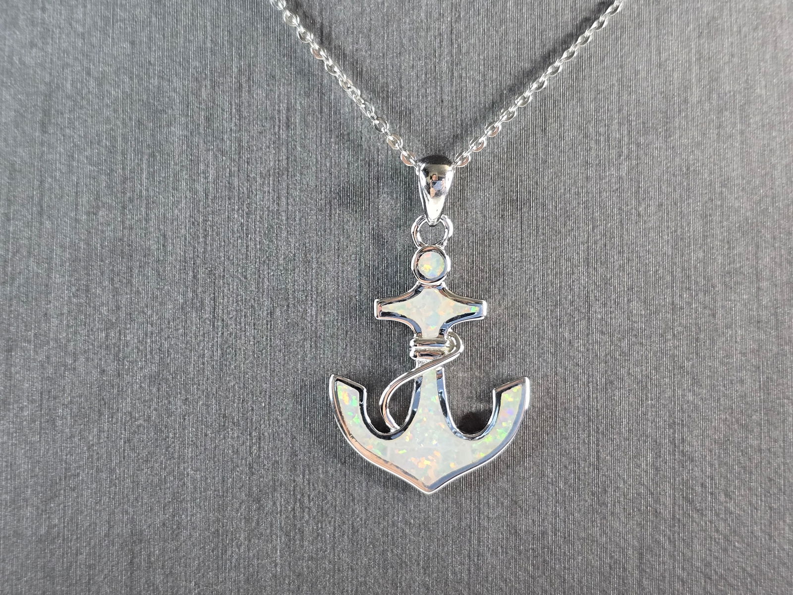 Womens Sterling Silver Opal Anchor Pendant Necklace: A WOMENS STERLING SILVER OPAL ANCHOR PENDANT WITH NECKLACE. THE PENDANT AND NECKLACE WEIGHS 4.5g. THE PENDANT MEASURES 1 1/4" LONG BY 3/4" WIDE, AND THE NECKLACE MEASURES 18" LONG. NOT SURE IF STONES