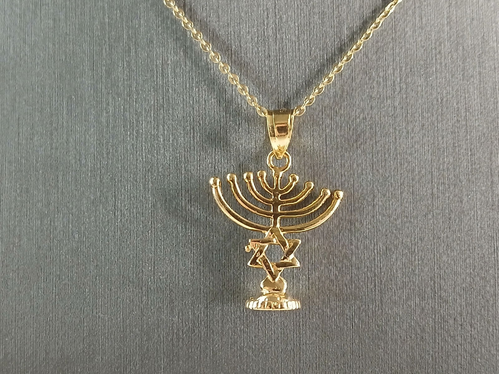 Sterling Silver Gold Tone Jewish Judaica Candelabra Pendant Necklace: A STERLING SILVER GOLD TONE JEWISH HEBREW CANDELABRA PENDANT WITH NECKLACE. PENDANT WITH NECKLACE WEIGHS 3.6g. THE NECKLACE MEASURES 18" LONG AND THE PENDANT MEASURES 1" LONG BY 3/4" WIDE. MAKES A GRE
