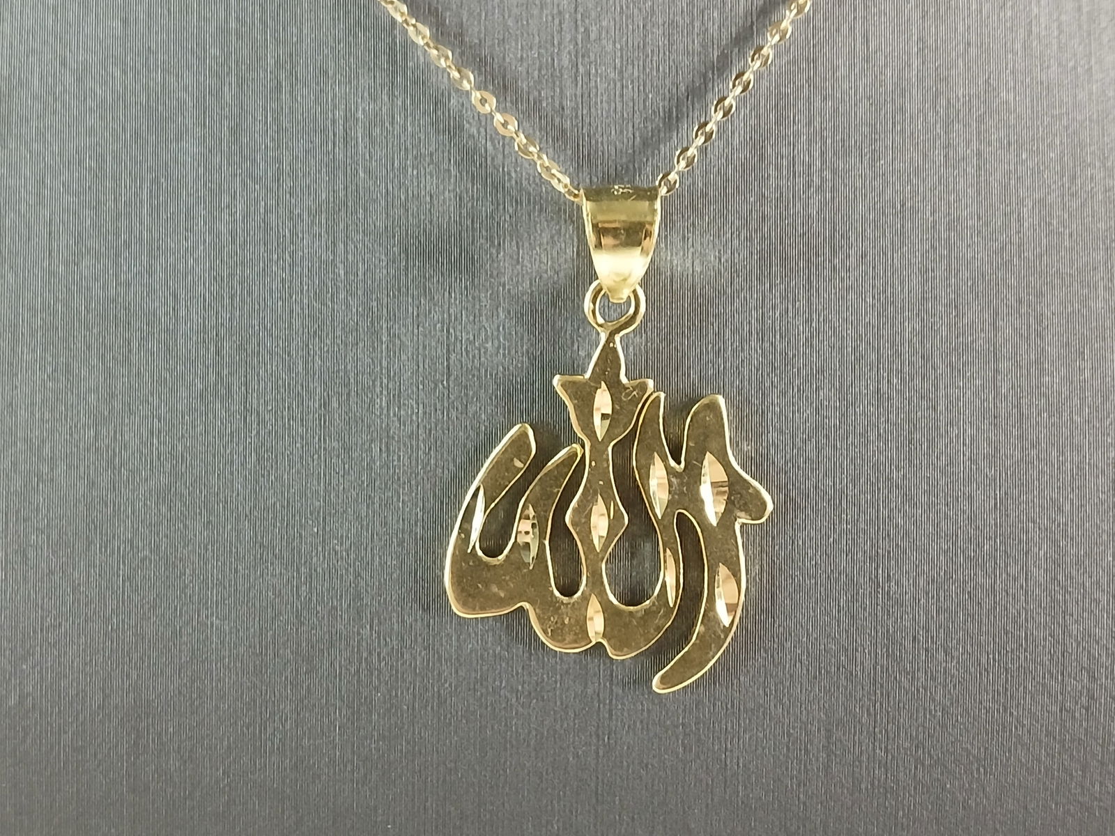 Sterling Silver Gold Tone Muslim Allah Pendant Necklace: A STERLING SILVER GOLD TONE MUSLIM ALLAH PENDANT WITH NECKLACE. THE PENDANT WITH NECKLACE WEIGHS 4.5g. THE PENDANT MEASURES 1 1/4" LONG BY 3/4" WIDE. THE NECKLACE MEASURES 18" LONG BUT IS ADJUSTABLE T