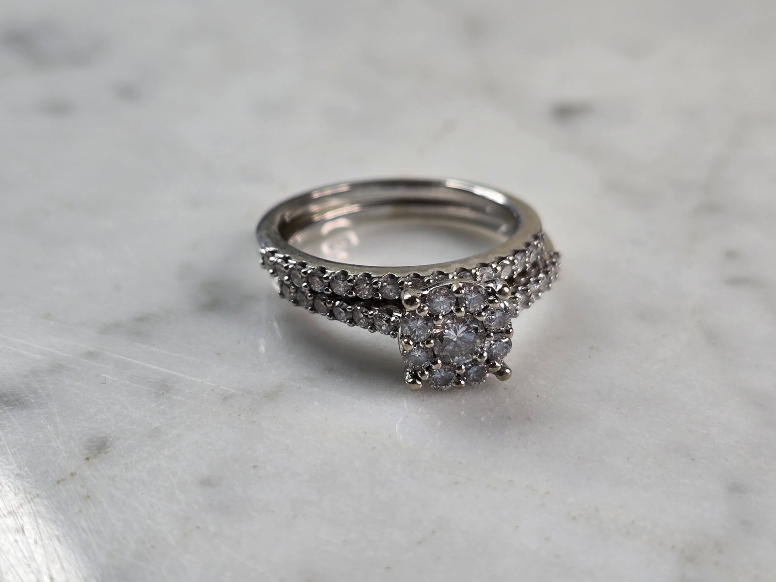 Womens Vintage Estate 10K White Gold Diamond Wedding Ring: A WOMENS VINTAGE ESTATE 10K WHITE GOLD DIAMOND RING SET. THE RING IS A SIZE 7.0, AND WEIGHS 4.6g. RING HAS ABOUT 0.85cts OF DIAMONDS. THE WIDTH OF THE TWO TOGETHER IS 5/16". RINGS ARE MARKED ON THE IN