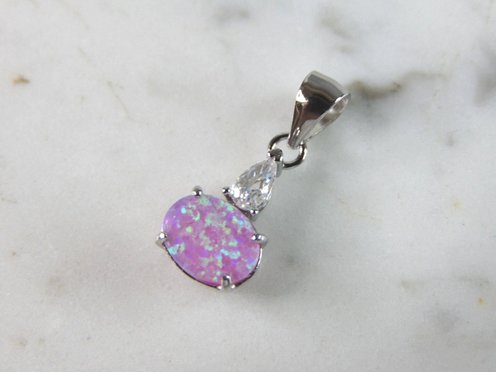 Womens Estate Sterling Silver Modernist Pink Opal Pendant: WOMENS ESTATE STERLING SILVER MODERNIST PINK OPAL COLORED PENDANT WEIGHES 1.1g AND MEASURES 7/8" LONG BY 3/8" WIDE. NOT SURE IF STONES ARE REAL OR MAN MADE. ANY QUESTIONS, PLEASE DO NOT HESITATE TO AS