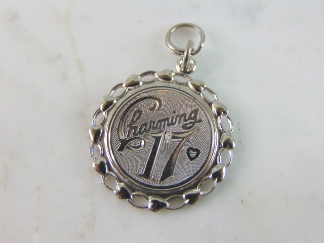 Womens Vintage Estate Charming 17 Charm Pendant: A WOMENS VINTAGE ESTATE "CHARMING 17" CHARM PENDANT. CHARM WEIGHS 4.8g AND MEASURES 1 3/8" LONG BY 7/8" WIDE. CHARM IS NOT STERLING. THE BALE IS MARKED "STER" MAKES A GREAT GIFT FOR THAT SOMEONE SPECI