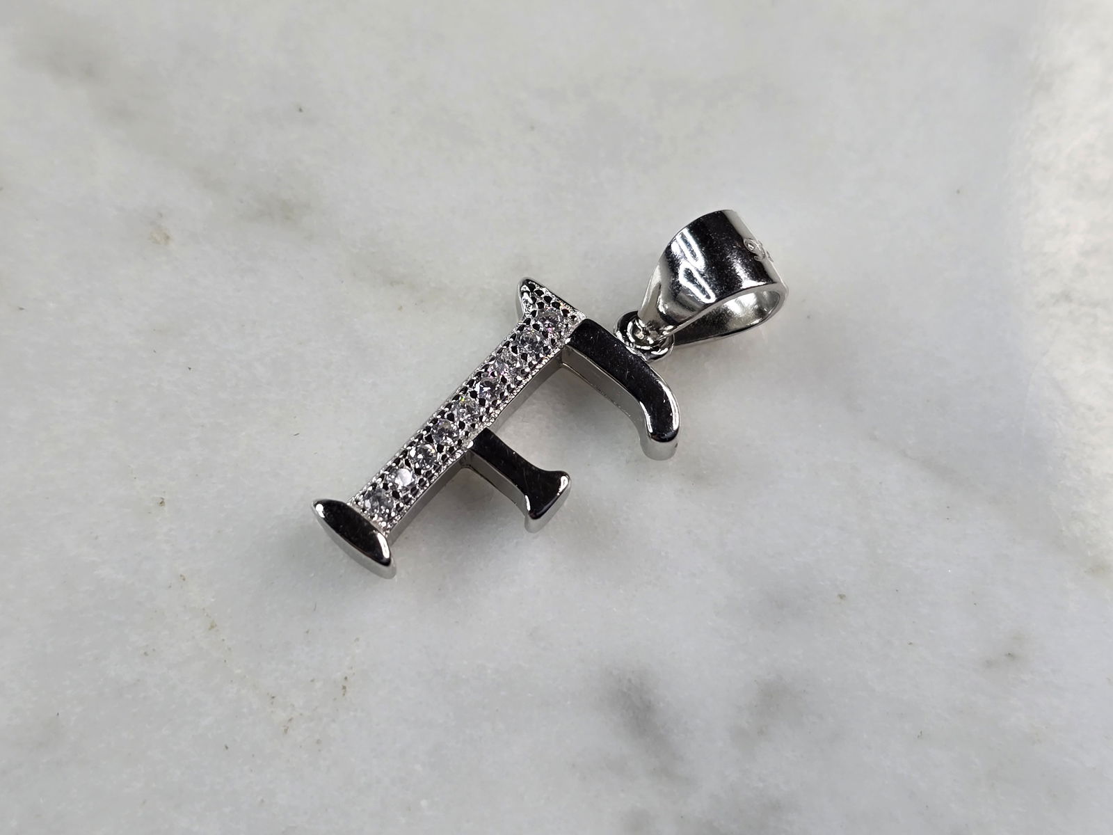 Womens Vintage Estate Sterling Silver CZ Letter "F" Pendant: FOR SALE IS THIS WOMENS VINTAGE ESTATE STERLING SILVER CZ LETTER "F" PENDANT. PENDANT WEIGHS 1.3g AND PENDANT MEASURES 7/8" LONG BY 3/8" WIDE. MAKES A GREAT GIFT FOR THAT SOMEONE SPECIAL. IF ANY QUEST