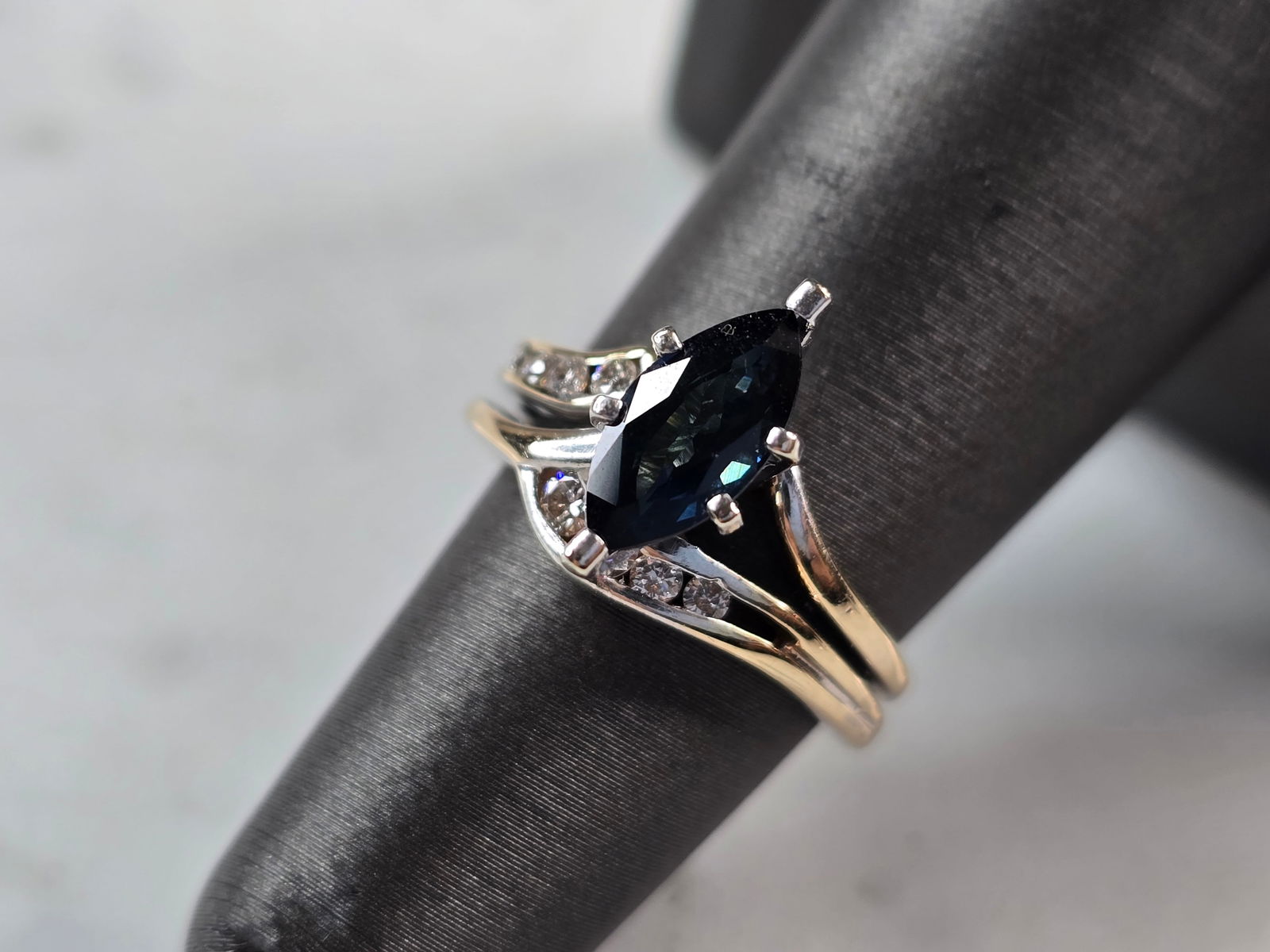 Womens Vintage Estate 14K Yellow & White Gold Sapphire Diamond Ring: A WOMENS VINTAGE ESTATE 14K YELLOW & WHITE GOLD RING WITH A BLUE SAPPHIRE MARQUISE STONE, AND ABOUT A .15cts OF DIAMONDS. THE CENTER SAPPHIRE IS ABOUT .75cts. THE RING WEIGHS 4.7g. THE SIZE OF THE RIN