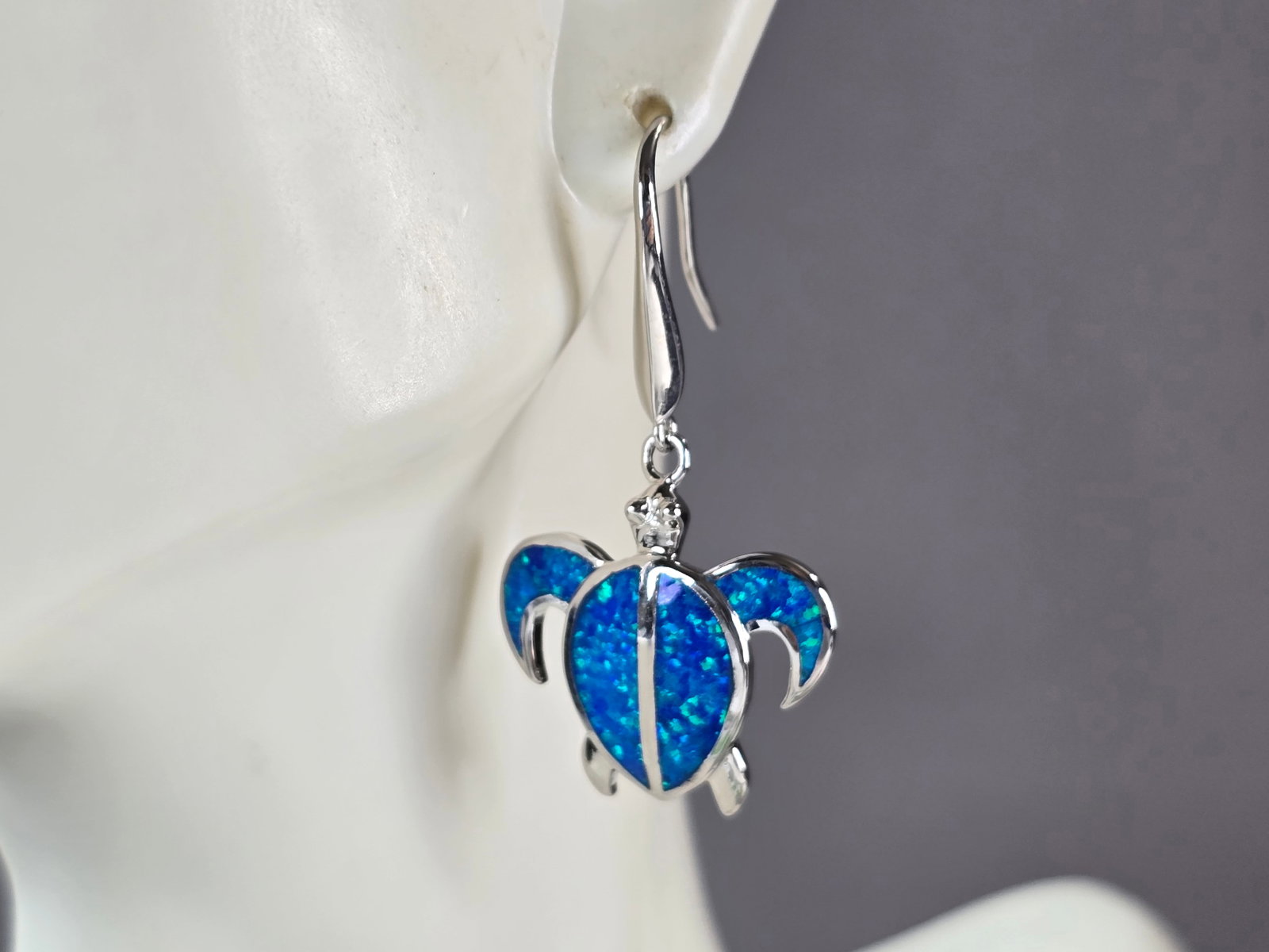 Womens Estate Sterling Silver Blue Opal Sea Turtle Earrings: A PAIR OF WOMENS STERLING SILVER BLUE OPAL COLORED SEA TURTLE EARRINGS THAT WEIGH 7.2g AND MEASURES 1 5/8" LONG BY 7/8" WIDE. NOT SURE IF STONES ARE REAL OR MAN MADE. ANY OTHER QUESTIONS, PLEASE DO NO