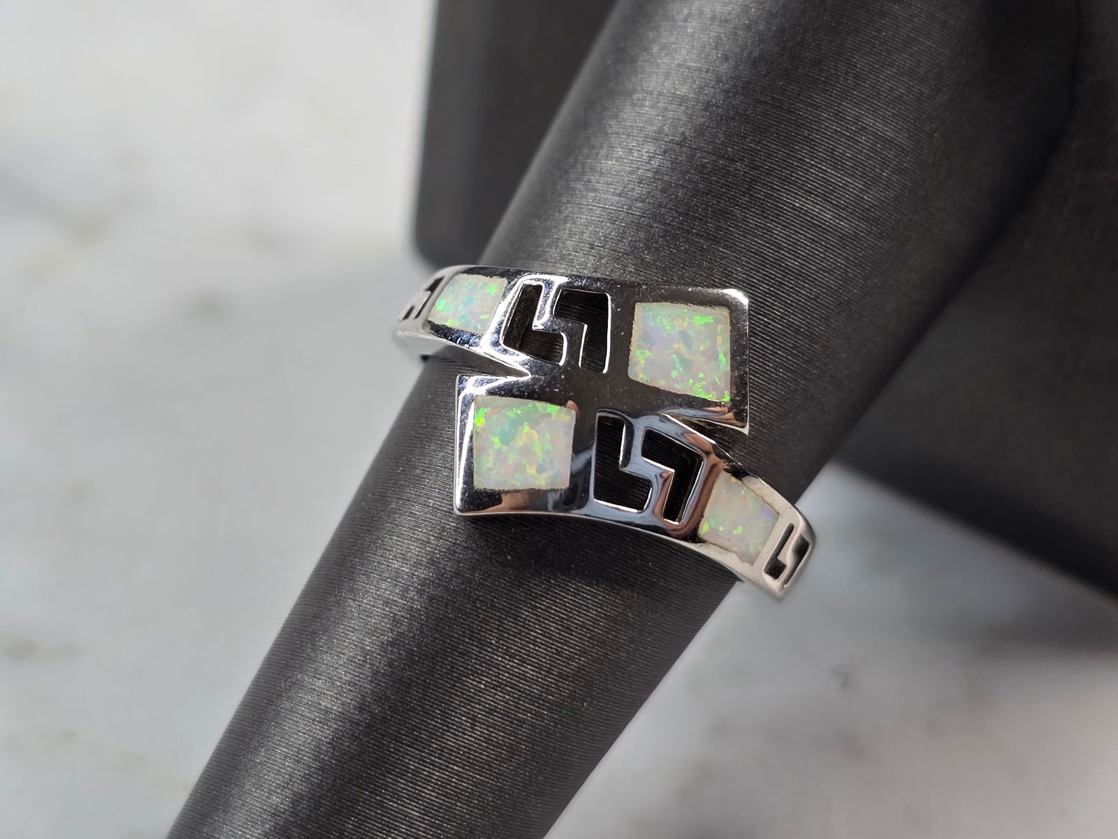 Womens Sterling Silver Modernist Greek Key Opal Ring: A WOMENS STERLING SILVER MODERNIST GREEK KEY OPAL RING. THE RING IS A SIZE 8.0, AND WEIGHS 4.0g. THE WIDTH OF THE RING MEASURES 1/2". NOT SURE IF THE STONES ARE REAL OR MAN MADE. RING MAKES A BEAUTIFU