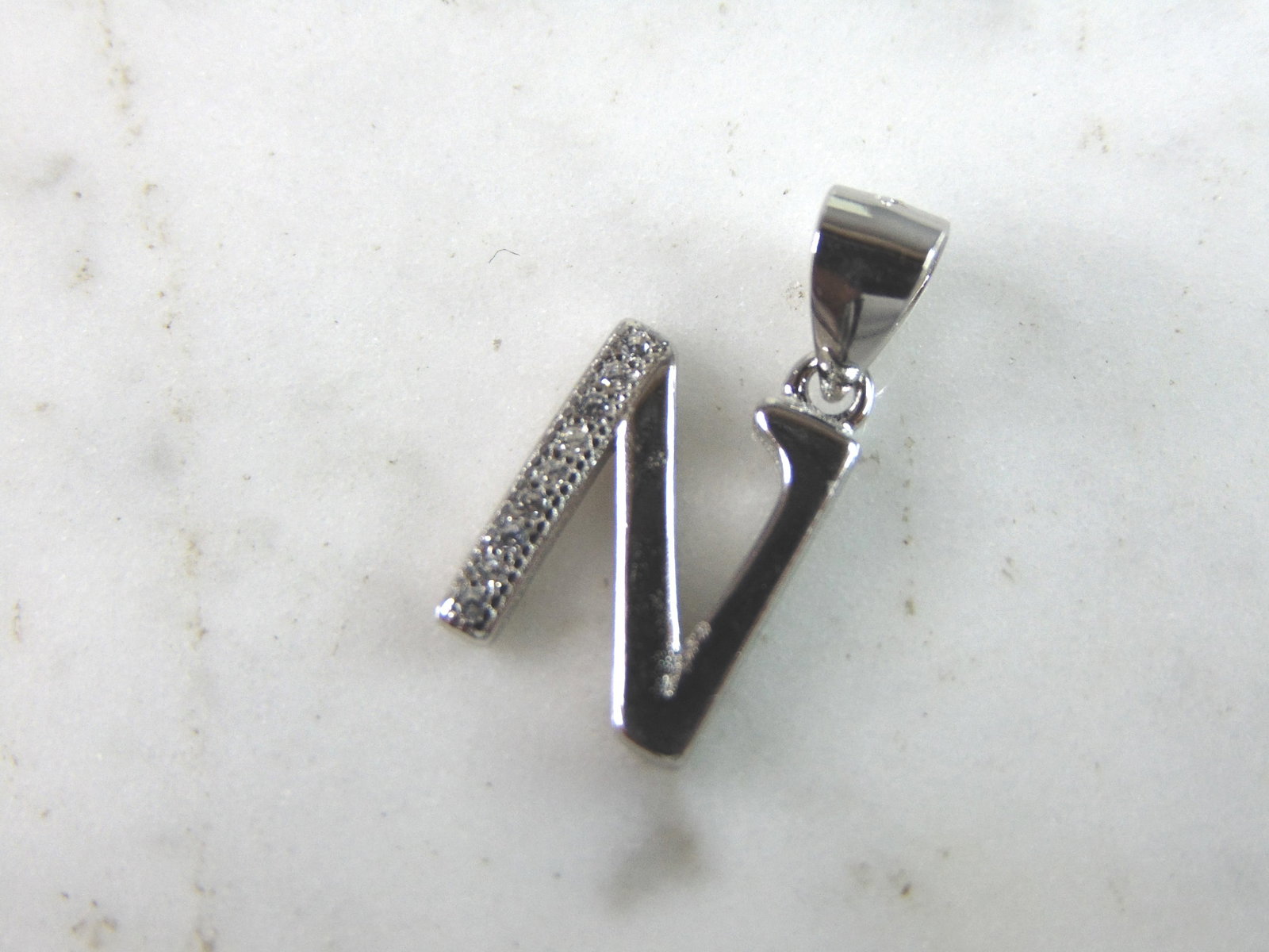 Womens Vintage Estate Sterling Silver CZ Letter "N" Pendant: FOR SALE IS THIS WOMENS VINTAGE ESTATE STERLING SILVER CZ LETTER "N" PENDANT. PENDANT WEIGHS 1.4g AND PENDANT MEASURES 3/4" LONG BY 3/8" WIDE. MAKES A GREAT GIFT FOR THAT SOMEONE SPECIAL. ANY QUESTION
