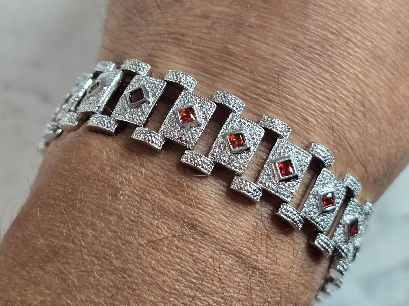 Womens Vintage Estate Sterling Silver Art Deco Bracelet: A WOMENS VINTAGE ESTATE STERLING SILVER ART DECO CZ BRACELET WITH RUBY COLORED STONES. BRACELET MEASURES 7 1/2" LONG AND 5/8" WIDE, AND WEIGHS 31.8g. NOT SURE IF THE STONES ARE NATURAL OR MAN MADE. WO
