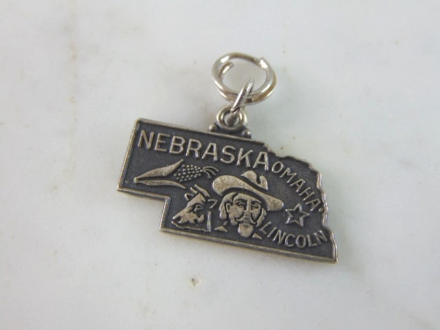 Womens Vintage Estate Sterling Silver Nebraska Charm: FOR SALE IS THIS WOMENS VINTAGE ESTATE STERLING SILVER NEBRASKA CHARM. CHARM WEIGHS 2.9g AND MEASURES 7/8" LONG BY 1" WIDE. MAKES A GREAT GIFT FOR THAT SOMEONE SPECIAL. ANY QUESTIONS, PLEASE ASK. BE S