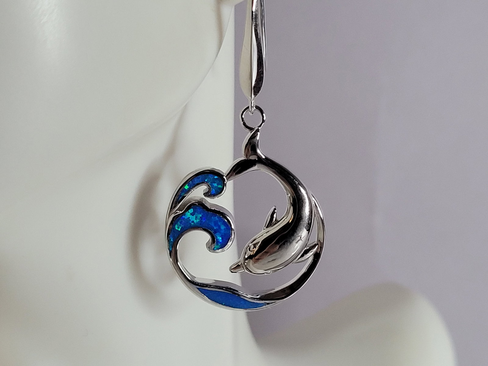 Womens Sterling Silver Modernist Blue Opal Dolphin Earrings: WOMENS STERLING SILVER MODERNIST BLUE OPAL COLORED DOLPHIN EARRINGS THAT WEIGHS 10.1g AND MEASURES 1 3/4" LONG BY 7/8" WIDE. NOT SURE IF STONES ARE REAL OR MAN MADE. ANY QUESTIONS, PLEASE DO NOT HESIT
