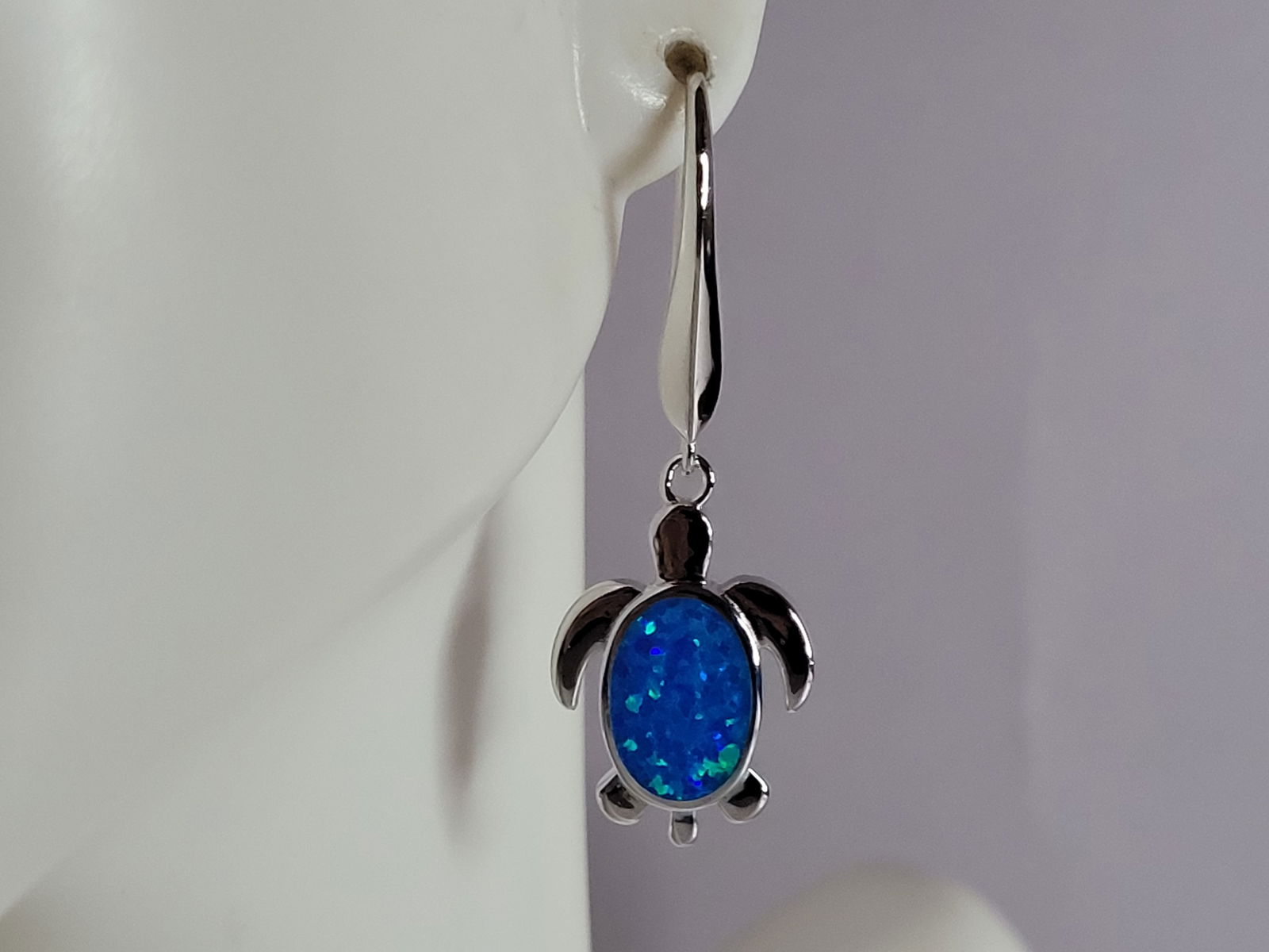 Womens Sterling Silver Blue Opal Sea Turtle Earrings: A PAIR OF WOMENS STERLING SILVER BLUE OPAL COLORED SEA TURTLE EARRINGS THAT WEIGH 4.9g AND MEASURES 1 1/2" LONG BY 1/2" WIDE. NOT SURE IF STONES ARE REAL OR MAN MADE. ANY QUESTIONS, PLEASE DO NOT HESI