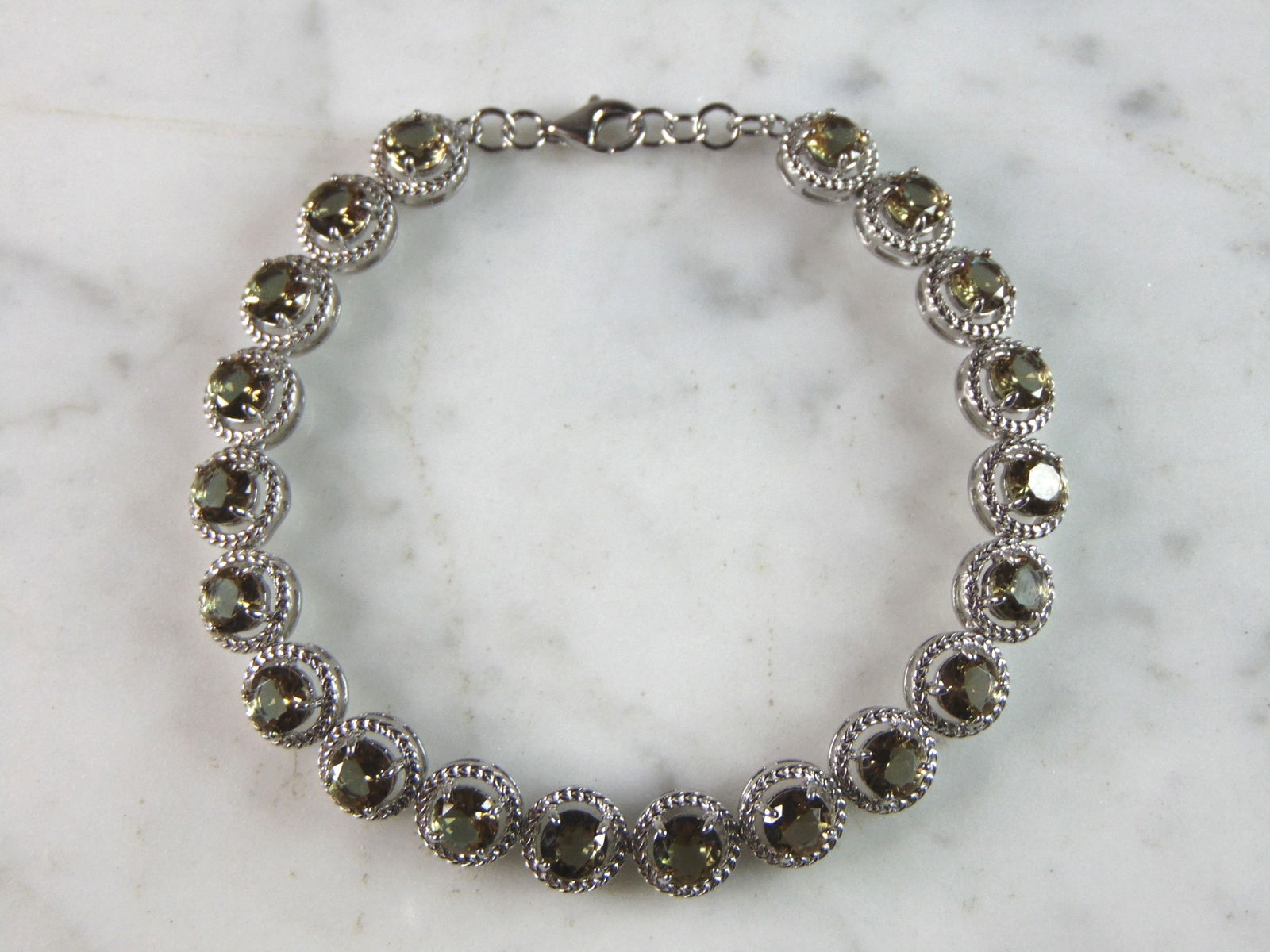 Womens Estate Sterling Silver Modernist Citrine Bracelet: A WOMENS ESTATE .925 STERLING SILVER MODERNIST CITRINE COLORED BRACELET. BRACELET MEASURES 7 1/2" LONG BY 1/4" WIDE AND WEIGHS 13.8g. THIS WOULD MAKE A LOVELY GIFT FOR THAT SOMEONE SPECIAL. ANY QUESTI