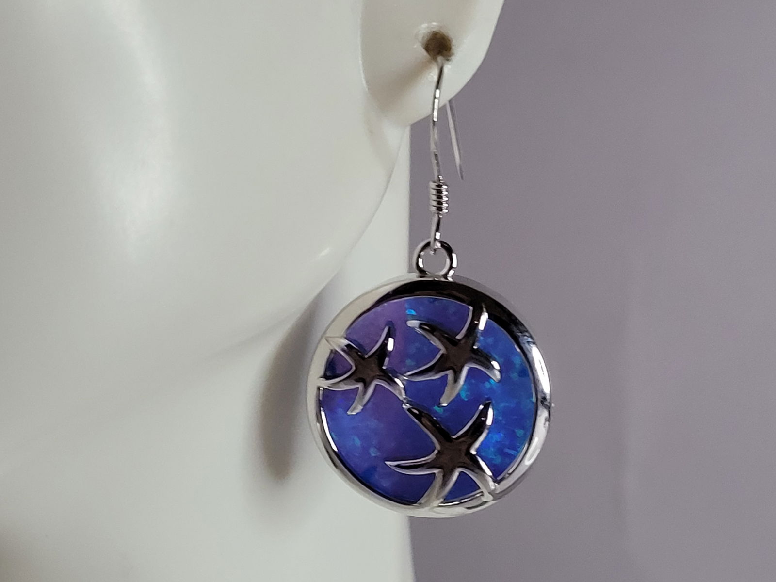 Womens Sterling Silver Blue Opal Star Fish Earrings: A WOMENS ESTATE STERLING SILVER BLUE OPAL STAR FISH EARRINGS. NOT SURE IF STONES ARE REAL OR MAN MADE. THE EARRINGS WEIGH 7.0g AND MEASURES 1 1/4" LONG BY 3/4" WIDE. MAKES A GREAT GIFT FOR THAT SOMEON