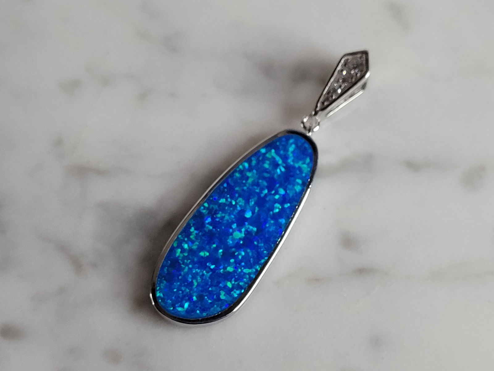 Womens Sterling Silver Blue Opal Modernist Pendant: A WOMENS ESTATE STERLING SILVER BLUE OPAL MODERNIST PENDANT. NOT SURE IF STONES ARE REAL OR MAN MADE. THE PENDANT WEIGHS 3.7g AND MEASURES 1 5/8" LONG BY 1/2" WIDE. MAKES A GREAT GIFT FOR THAT SOMEONE