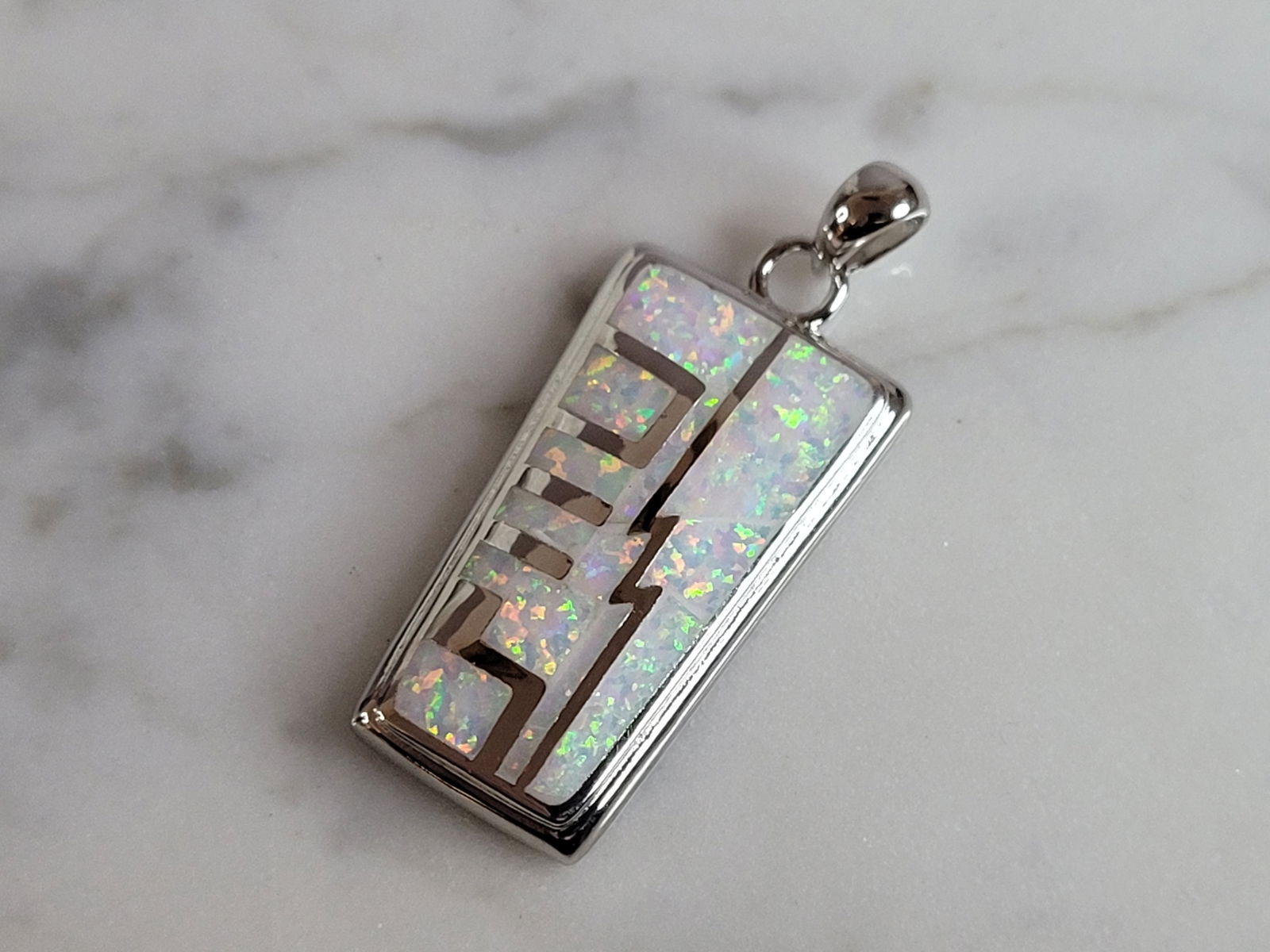Womens Estate Sterling Silver Modernist Opal Pendant: WOMENS ESTATE STERLING SILVER MODERNIST OPAL COLORED PENDANT WEIGHES 9.8g AND MEASURES 1 3/8" LONG BY 1/2" WIDE. NOT SURE IF STONES ARE REAL OR MAN MADE. ANY OTHER QUESTIONS, PLEASE DO NOT HESITATE TO