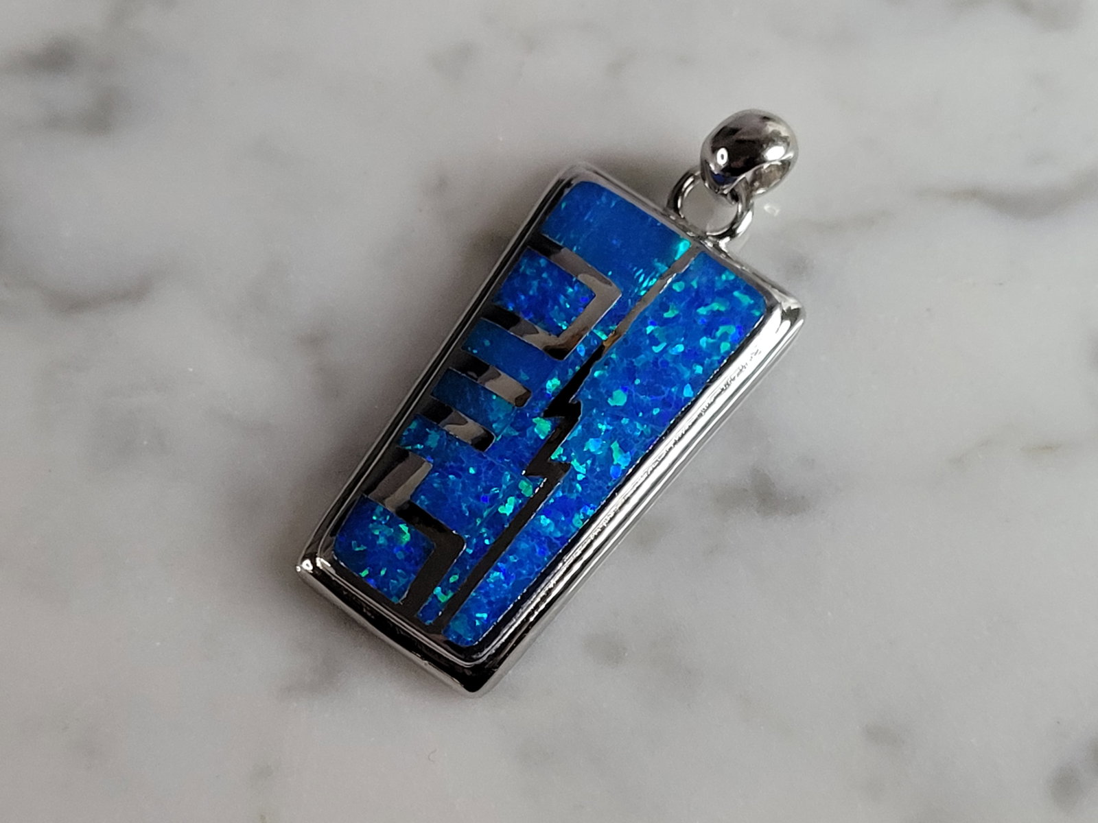 Womens Sterling Silver Modernist Blue Opal Pendant: WOMENS STERLING SILVER MODERNIST BLUE OPAL COLORED PENDANT WEIGHS 10.1g AND MEASURES 1 3/8" LONG BY 1/2" WIDE. NOT SURE IF STONES ARE REAL OR MAN MADE. ANY QUESTIONS, PLEASE DO NOT HESITATE TO ASK. BE