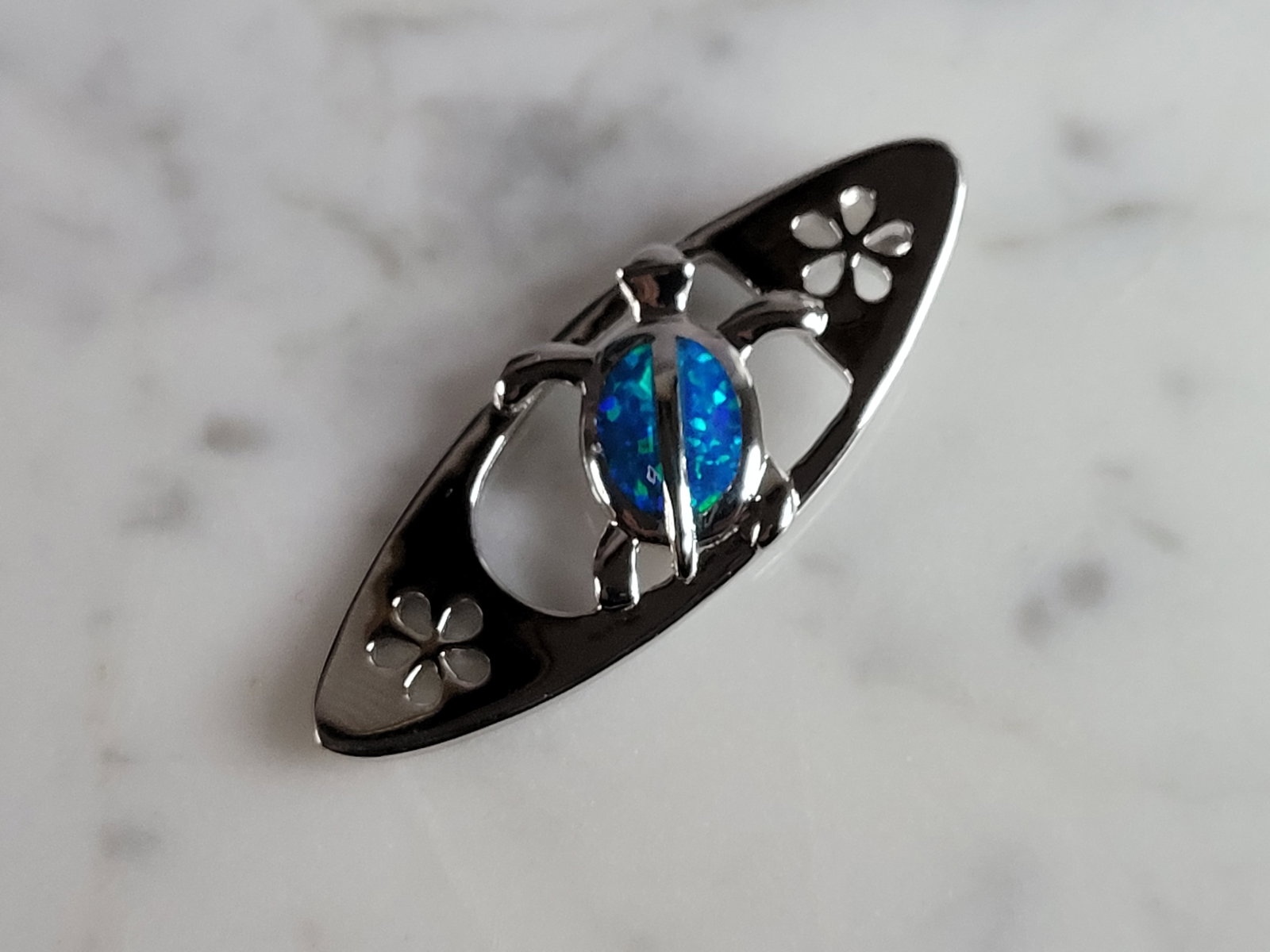 Womens Sterling Silver Opal Surfing Sea Turtle Pendant: A WOMENS STERLING SILVER BLUE OPAL SURFING SEA TURTLE. NOT SURE IF STONES ARE REAL OR MAN MADE. THE PENDANT WEIGHS 3.8g AND MEASURES 1 1/2" LONG BY 1/2" WIDE. MAKES A GREAT GIFT FOR THAT SOMEONE SPECI
