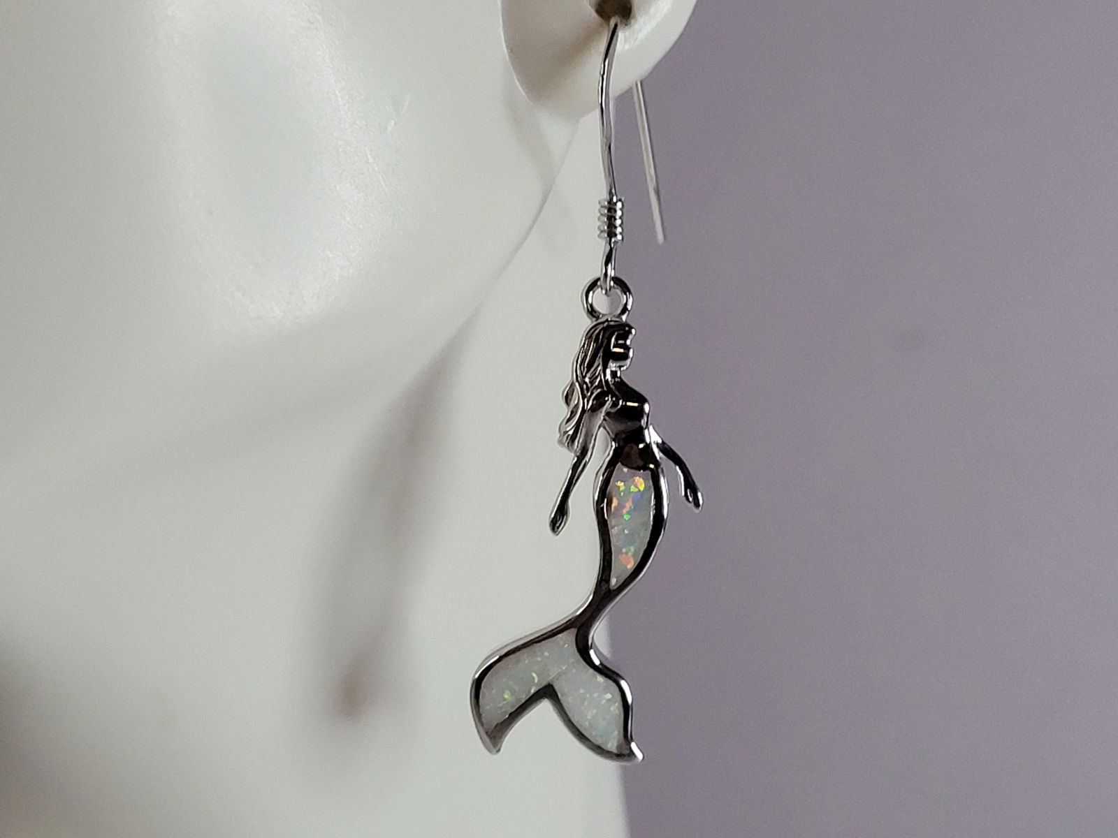 Womens Sterling Silver Modernist Opal Mermaid Earrings: A PAIR OF WOMENS STERLING SILVER OPAL COLORED MERMAID EARRINGS THAT WEIGH 5.1g AND MEASURES 1 5/8" LONG BY 3/8" WIDE. NOT SURE IF STONES ARE REAL OR MAN MADE. ANY QUESTIONS, PLEASE DO NOT HESITATE TO
