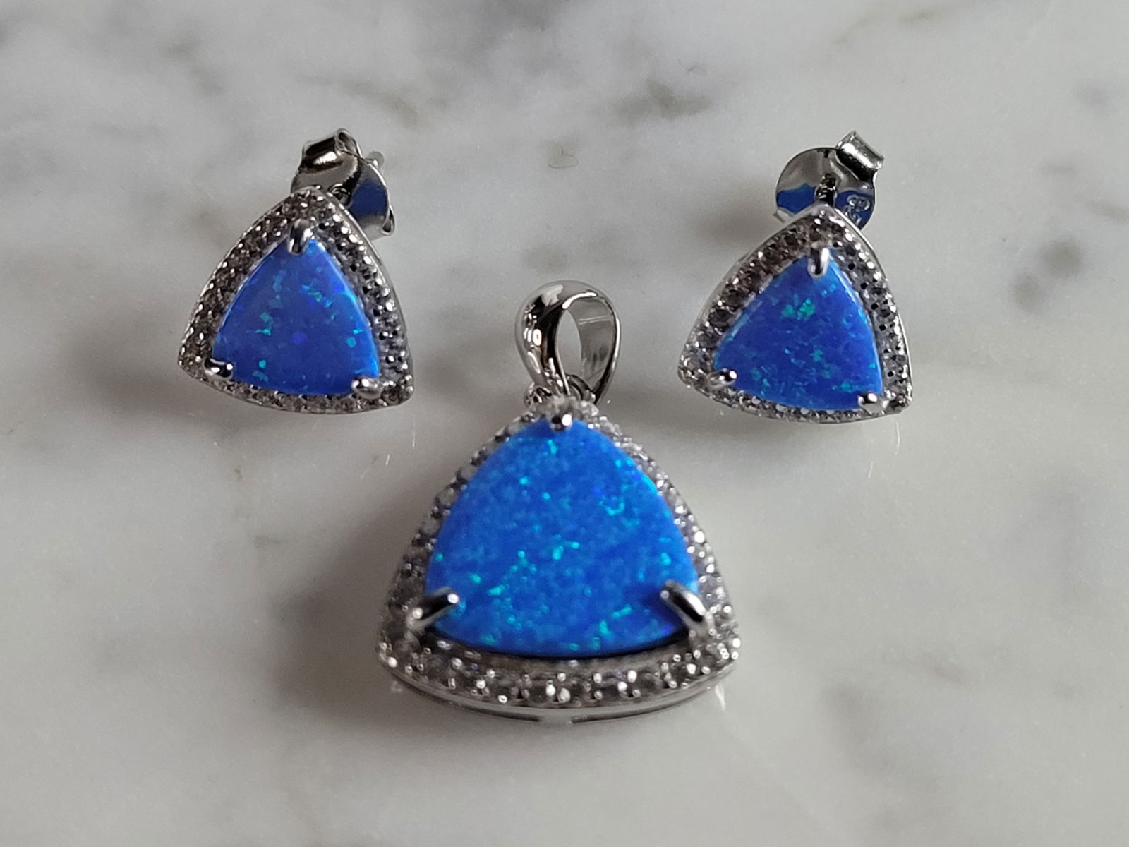 Womens Sterling Silver Modernist Blue Opal Earrings & Pendant Set: WOMENS STERLING SILVER MODERNIST BLUE OPAL COLORED EARRINGS & PENDANT SET THAT WEIGHES 4.8g TOGETHER. EARRINGS MEASURE 3/8" LONG BY 3/8" WIDE, AND PENDANT MEASURES 7/8" BY 5/8". NOT SURE IF STONES ARE