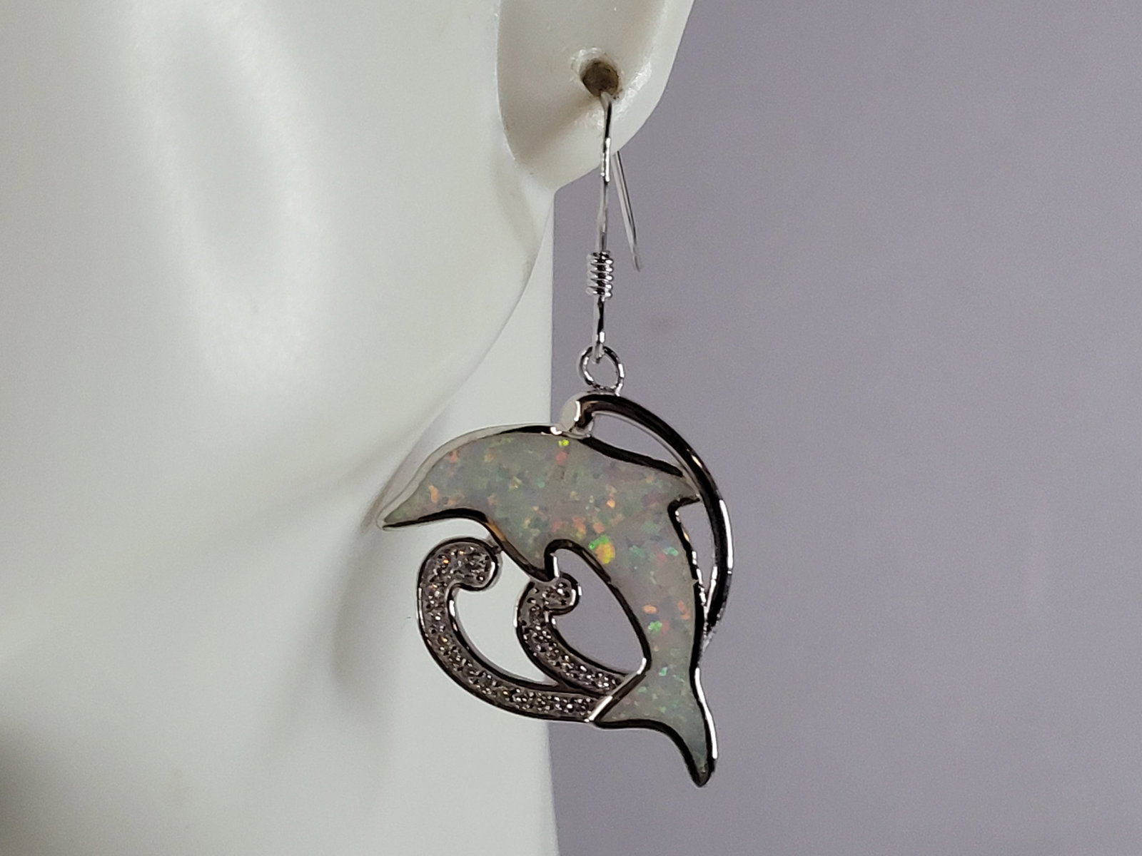Womens Sterling Silver Modernist Opal Dolphin Earrings: WOMENS STERLING SILVER MODERNIST OPAL COLORED DOLPHIN EARRINGS THAT WEIGHS 6.7g AND MEASURES 1 1/2" LONG BY 7/8" WIDE. NOT SURE IF STONES ARE REAL OR MAN MADE. ANY OTHER QUESTIONS, PLEASE DO NOT HESIT
