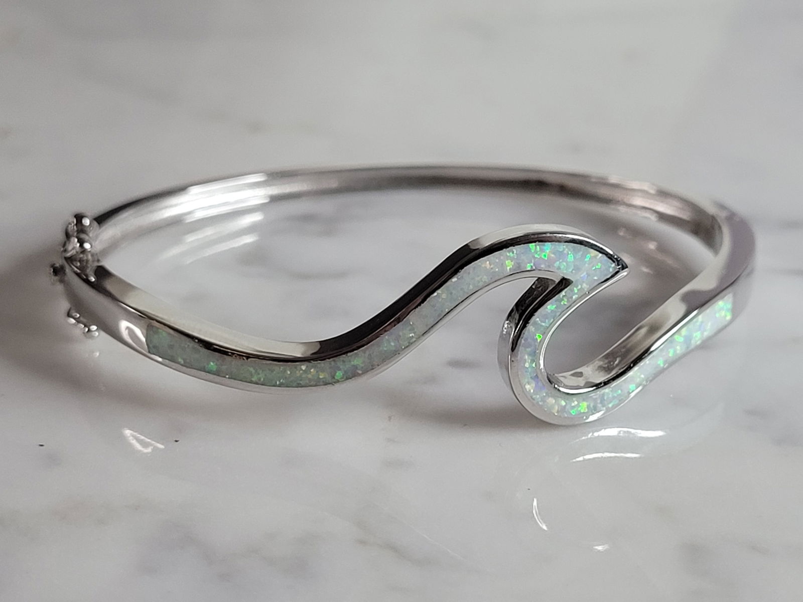 Womens Sterling Silver Modernist Opal Wave Bangle Bracelet: A WOMENS STERLING SILVER MODERNIST OPAL WAVE BANGLE BRACELET. THE BRACELET WEIGHS 19.1g AND IS ABOUT 5/8" WIDE. THE CIRCUMFERENCE WITH THE GAP IS 7". ANY QUESTIONS PLEASE DO NOT HESITATE TO ASK. BE SU