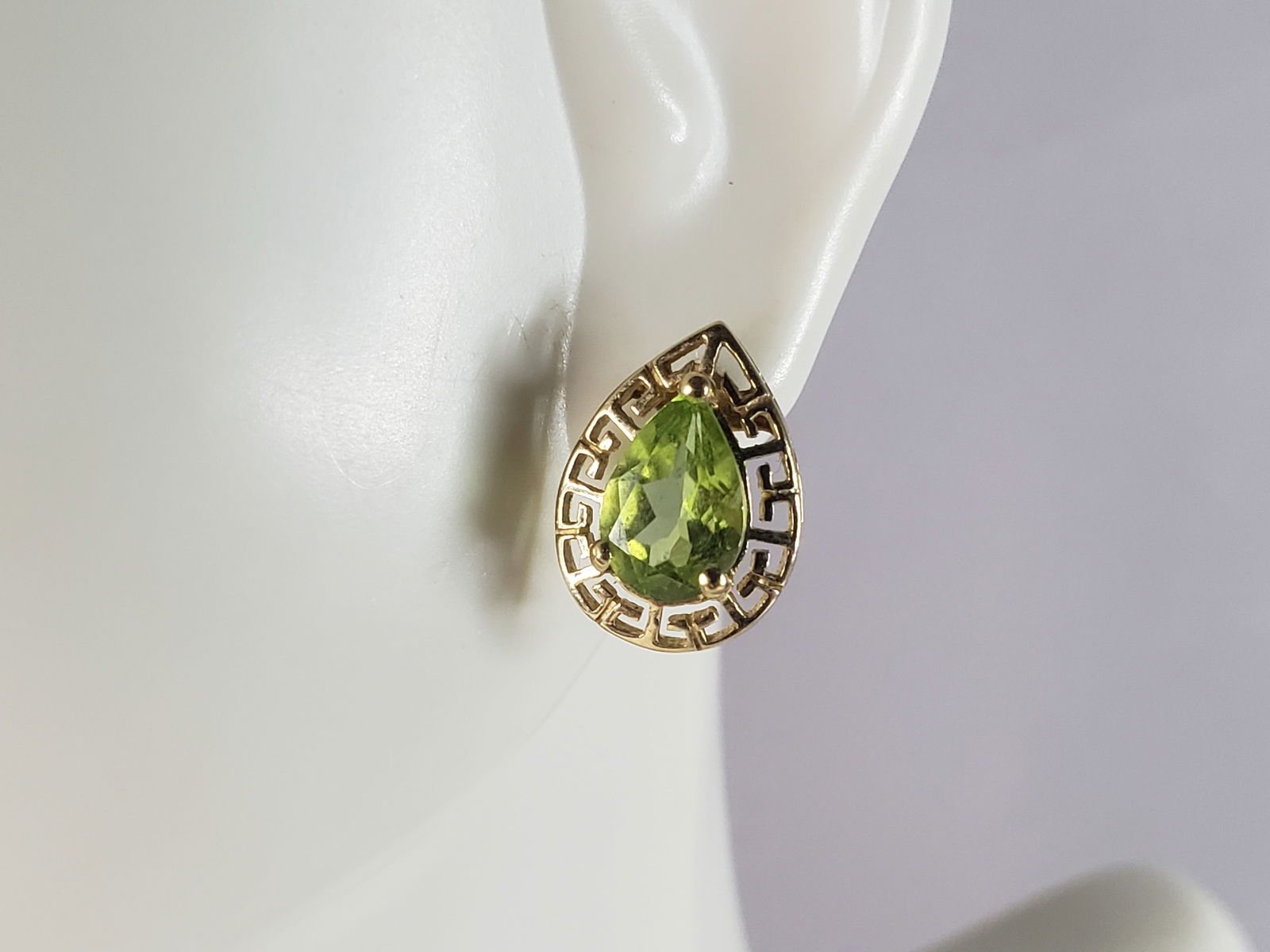 Pr Womens Vintage Estate 10K Yellow Gold Peridot Stick Earrings: A PAIR OF WOMENS VINTAGE ESTATE 10K GOLD PERIDOT STICK EARRINGS. THE PAIR OF EARRINGS WEIGH 2.1g. EARRINGS MEASURE 1/2" LONG BY 3/8" WIDE. EARRINGS ARE MARKED "10K, HN". BACKINGS ARE NOT GOLD, AND WER