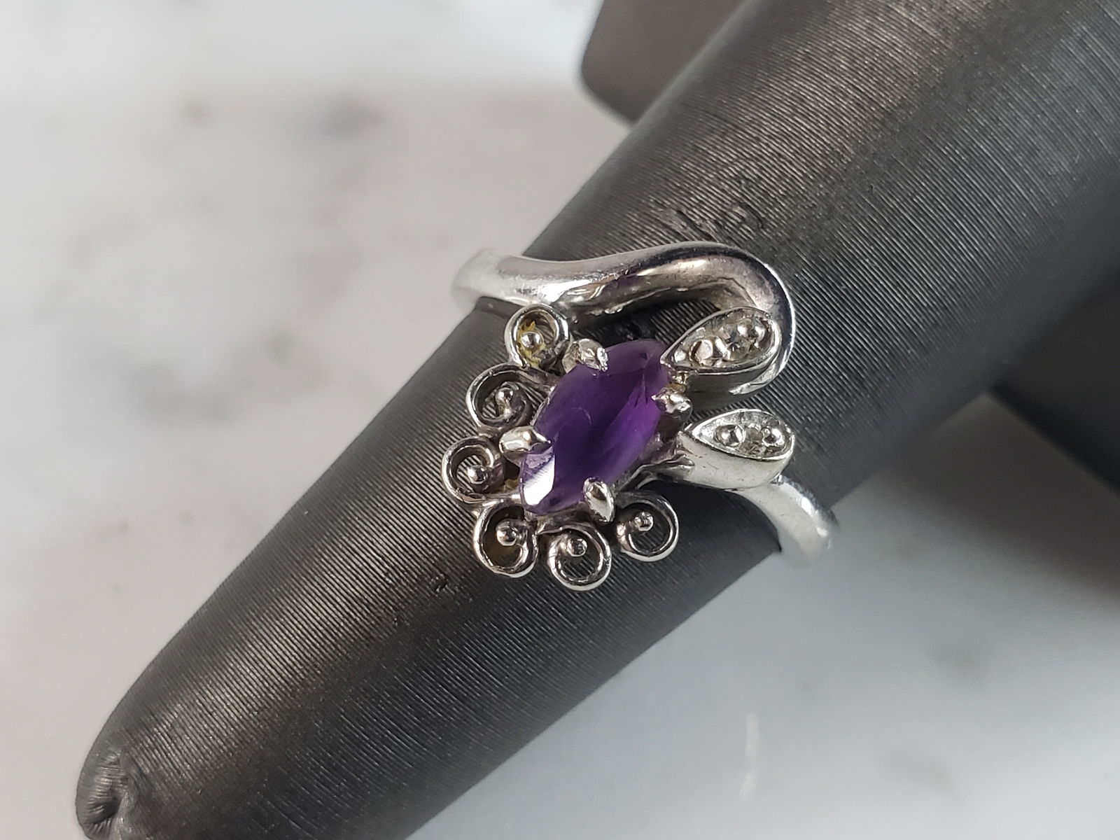 Womens Vintage Estate 14K White Gold Amethyst & Diamond Ring: A WOMEN'S VINTAGE ESTATE 14K WHITE GOLD RING WITH AN AMETHYST STONE AND TWO TINY DIAMOND CHIPS . THE RING WEIGHS 4.5g. THE RING SIZE IS A 6.0. THERE ARE ABOUT .02cts OF DIAMONDS. ANY QUESTIONS, PLEASE