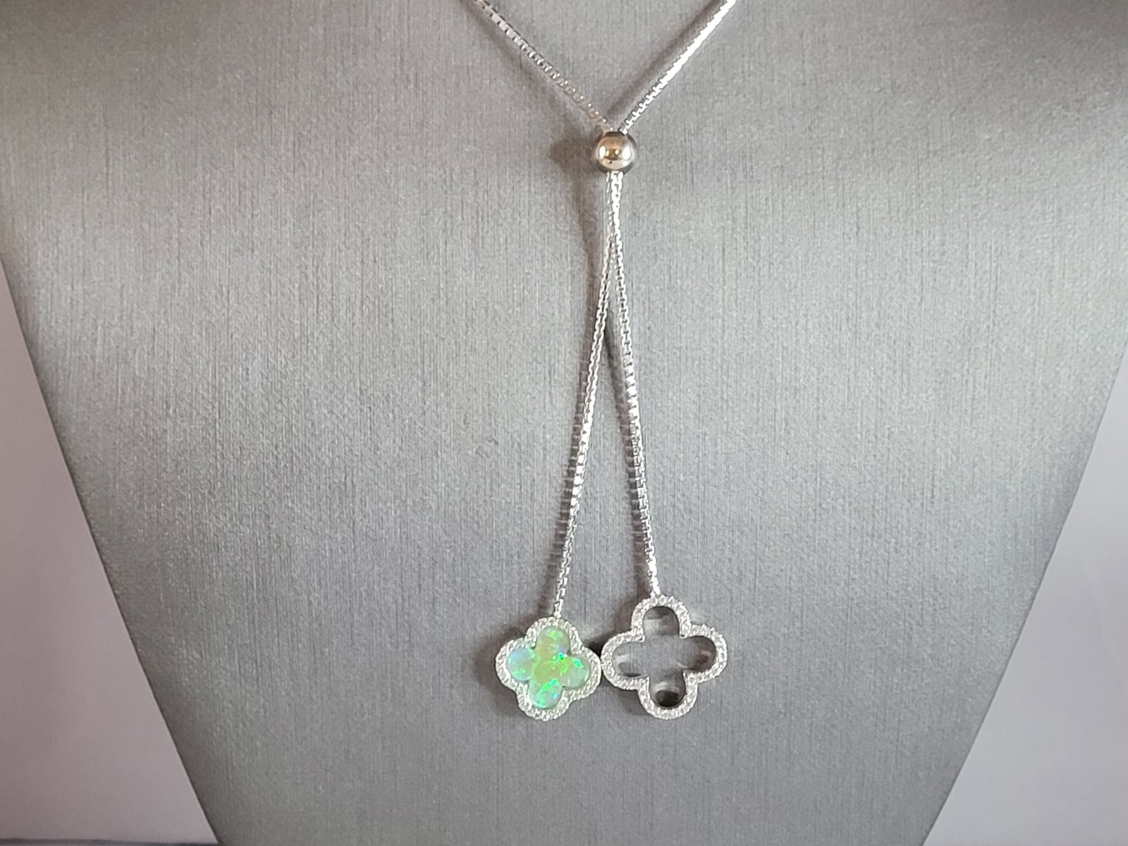 Womens Sterling Silver 4 Leaf Clover Necklace: A WOMENS STERLING SILVER 4 LEAF CLOVER TASSLE NECKLACE. NOT SURE IF STONES ARE NATURAL OR MAN MADE. NECKLACE MEASURES 15 1/2" LONG BY 1/2" WIDE AND WEIGHS 9.1g. KEEP IN MIND THIS IS A SLIP ON NECKLACE