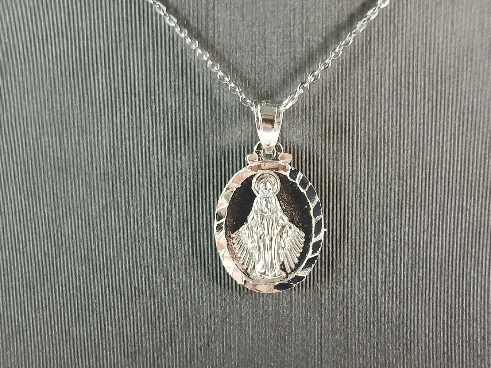 Womens Sterling Silver Virgin Mary Pendant Necklace: A WOMENS STERLING SILVER RELIGIOUS VIRGIN MARY PENDANT WITH NECKLACE . THE TOTAL WEIGHT IS 3.4g. THE PENDANT MEASURES 1 1/4" LONG BY 5/8" WIDE. THE NECKLACE MEASURES 18" LONG AND IS ADJUSTABLE TO 16"