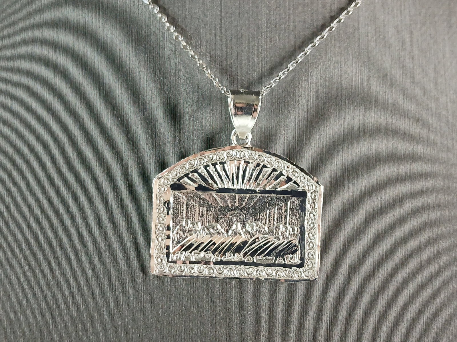 Sterling Silver Religious Last Supper Pendant Necklace: A STERLING SILVER RELIGIOUS LAST SUPPER PENDANT WITH NECKLACE. PENDANT WITH NECKLACE WEIGHS 6.4g. THE PENDANT MEASURES 1 1/4" LONG BY 1 1/8" WIDE. THE NECKLACE MEASURES 18" LONG AND IS ADJUSTABLE TO 1