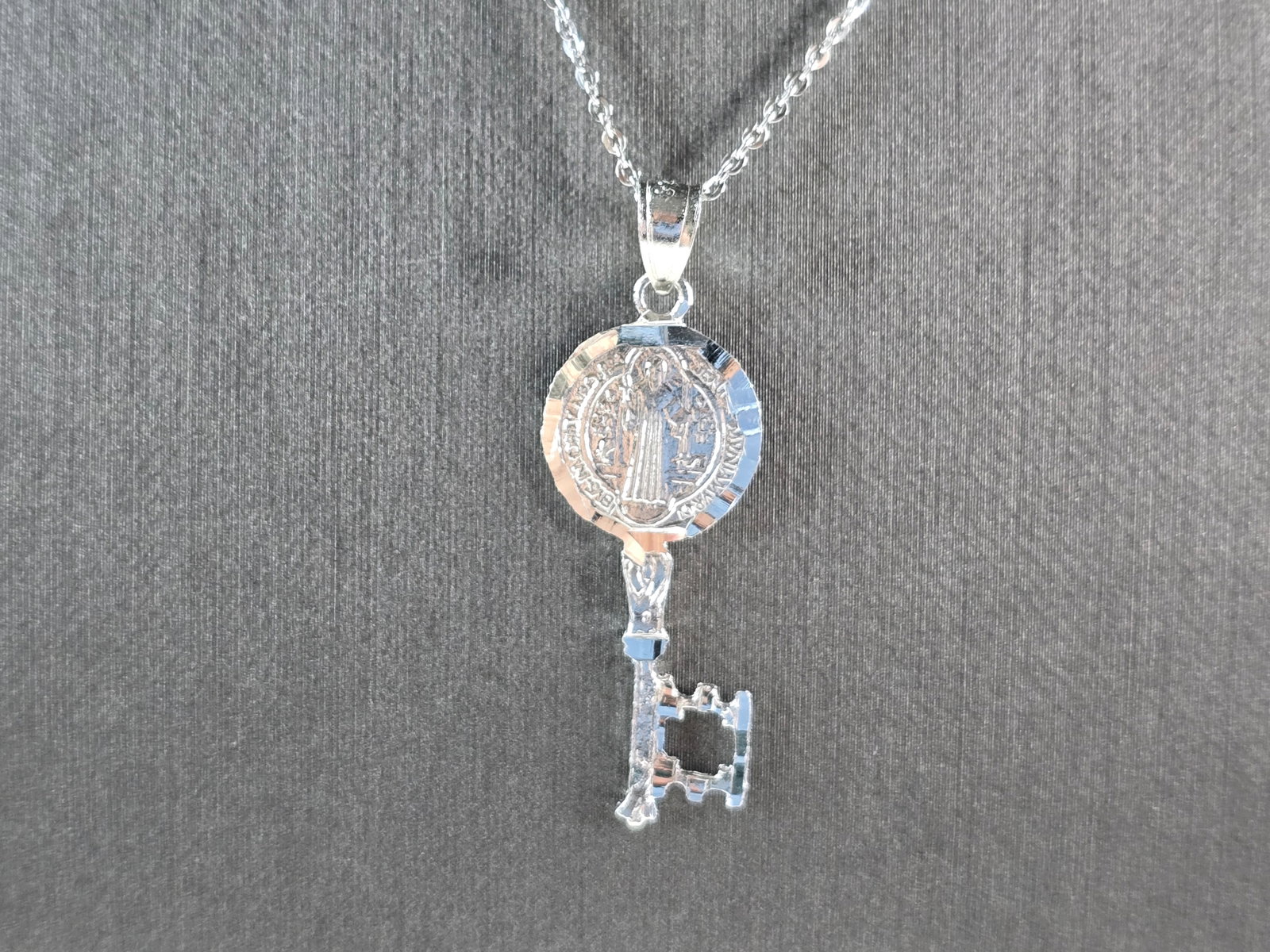 Womens Sterling Silver Religious Saint Benedict Key Pendant Necklace: A WOMENS STERLING SILVER RELGIOUS SAINT BENEDICT KEY PENDANT WITH NECKLACE . THE TOTAL WEIGHT IS 3.3g. THE PENDANT MEASURES 1 1/2" LONG BY 1/2" WIDE, AND THE NECKLACE MEASURES 18"LONG. MAKES A GREAT G