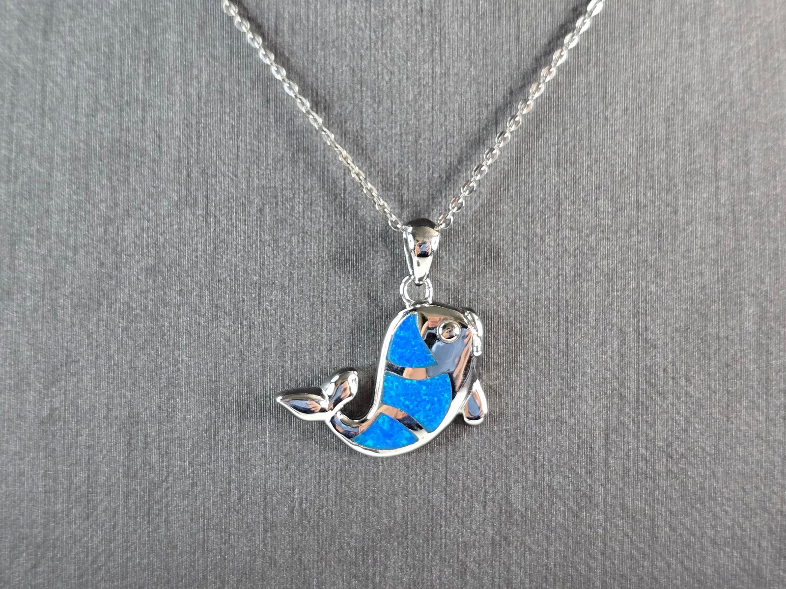Womens Sterling Silver Blue Opal Fish Pendant Necklace: A WOMENS STERLING SILVER BLUE OPAL FISH PENDANT WITH NECKLACE. THE PENDANT WITH NECKLACE WEIGHS 6.4g. THE PENDANT MEASURES 1" LONG BY 3/4" WIDE, AND THE NECKLACE MEASURES 18" LONG, ADJUSTABLE TO 16" L