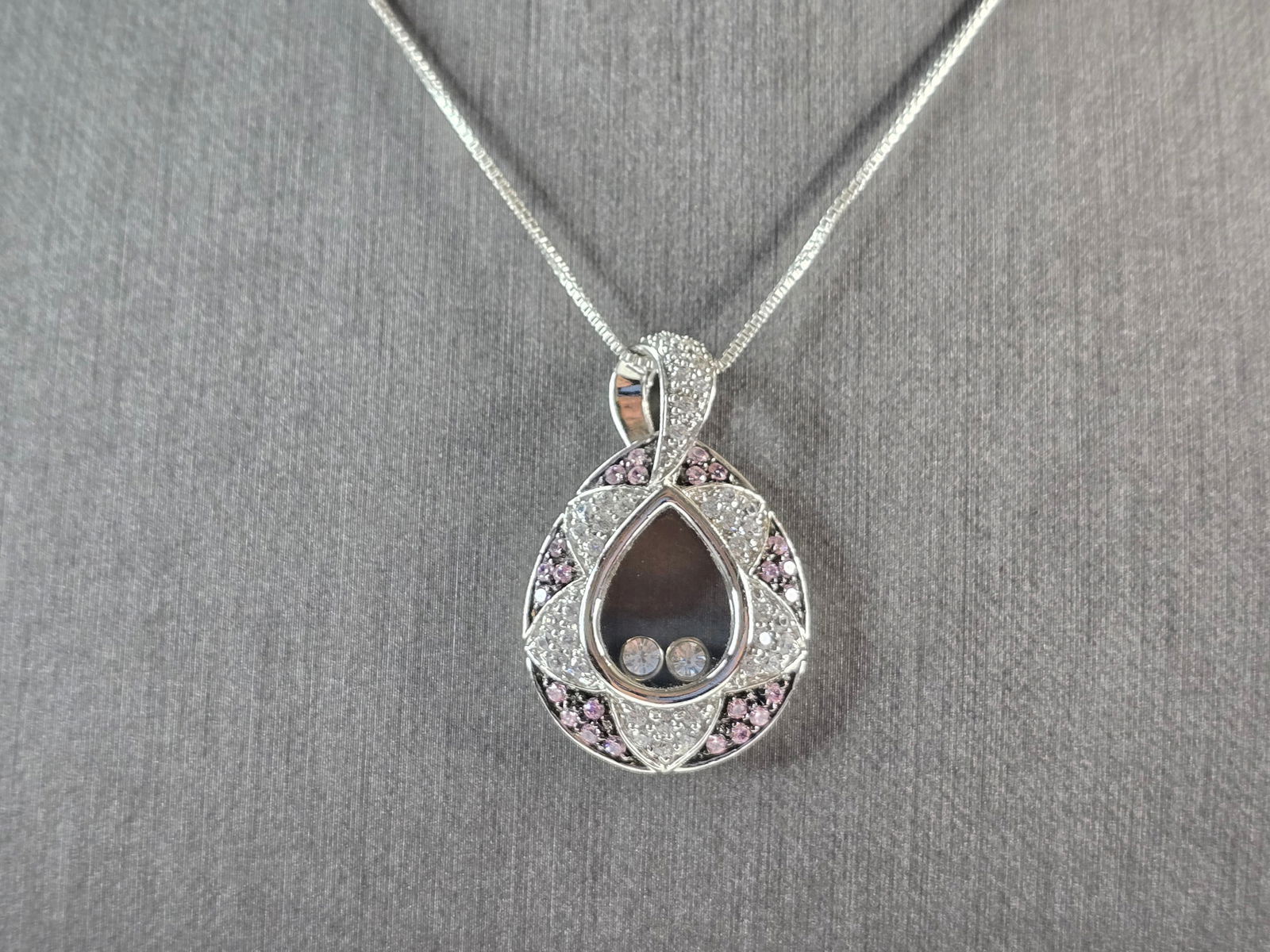 Womens Estate Sterling Silver Modernist Amethyst CZ Pendant Necklace: A WOMENS VINTAGE ESTATE STERLING SILVER AMETHYST & CZ PENDANT WITH NECKLACE. THE PENDANT MEASURES 1 1/4" BY 3/4". THE NECKLACE MEASURES 18" LONG. TOGETHER THEY WEIGH 9.4g. NOT SURE IF THE STONE IS NAT