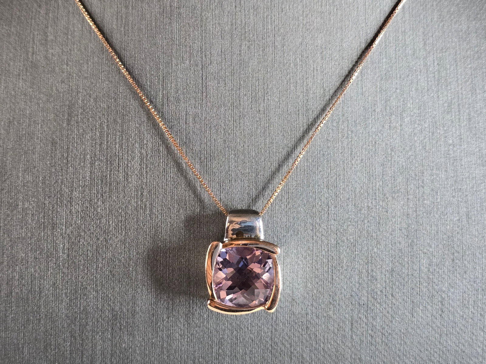Womens Sterling Silver 14K Gold Amethyst Pendant W/ Necklace: A WOMENS VINTAGE ESTATE STERLING SILVER AND 14K GOLD AMETHYST COLORED STONE PENDANT WITH NECKLACE. NOT SURE IF STONE IS NATURAL OR MAN MADE. TOGETHER NECKLACE AND PENDANT WEIGHS 8.4g. PENDANT MEASURES