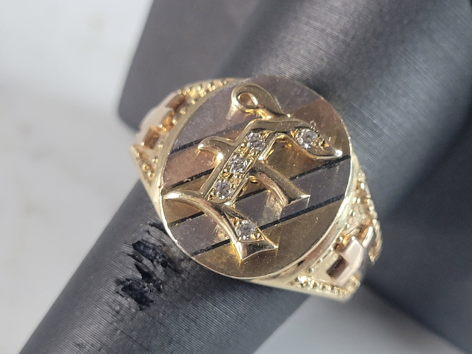 Mens Vintage Estate 14K Multi Gold Religious Cross "E" Diamond Ring: A MENS VINTAGE ESTATE 14K MULTI TONE GOLD RELIGIOUS CROSS RING WITH THE LETTER "E" ON THE FACE. THE RING SIZE IS A 10.0, AND WEIGHS 8.7g. THE WIDTH OF THE BAND IS ABOUT 5/8", AND HAS ABOUT .05CTS OF D