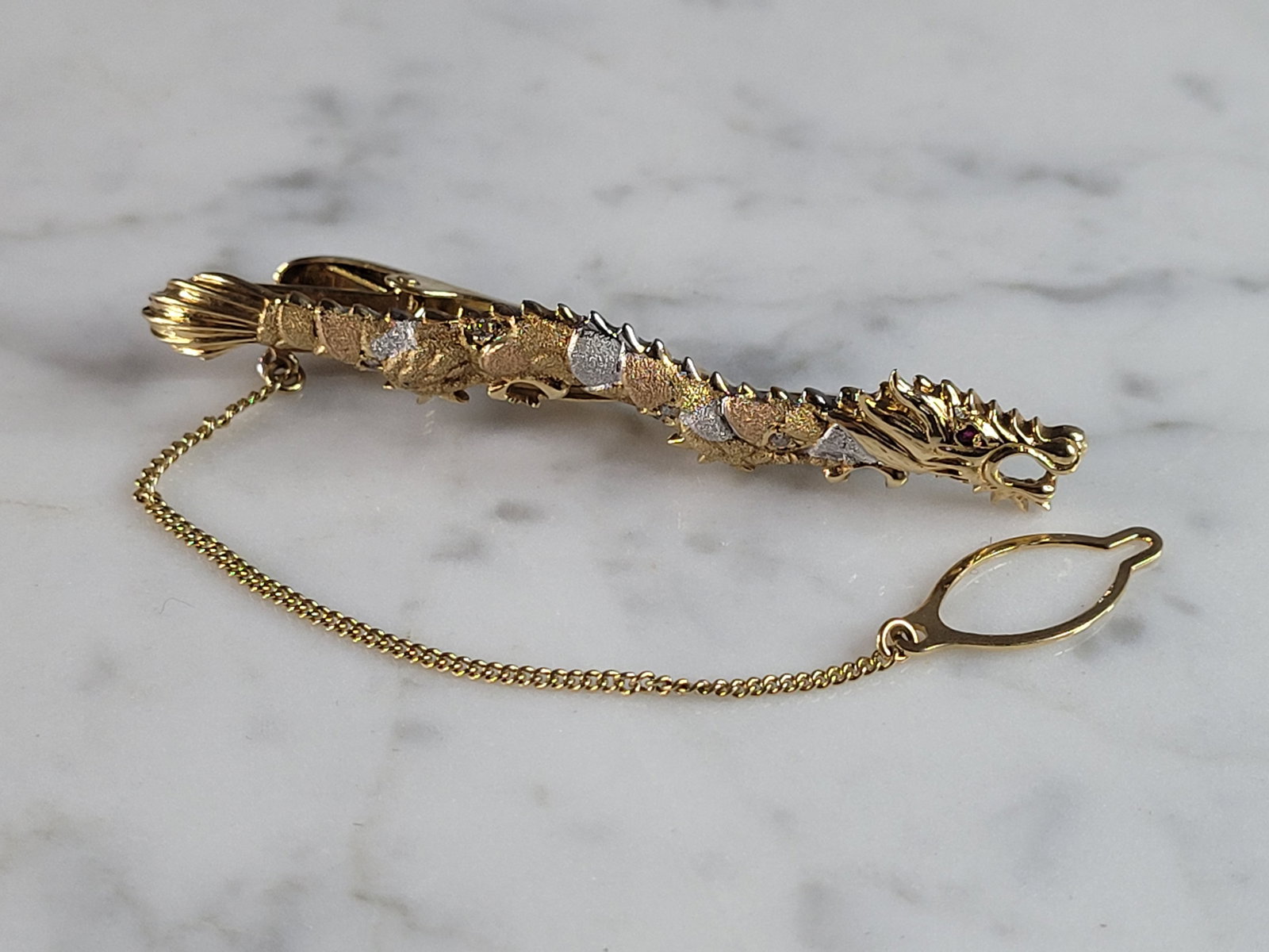 Womens Vintage Estate 14k Multi Gold Ruby Chinese Dragon Scarf Tie Clip: A WOMENS VINTAGE ESTATE 14k MULTI TONE GOLD CHINESE DRAGON TIE OR SCARF CLIP WITH A TINY RUBY EYE. THE CLIP WEIGHS 7.0g, AND MEASURES 2 1/8" LONG BY 1/4" WIDE. ANY QUESTIONS PLEASE DO NOT HESITATE TO
