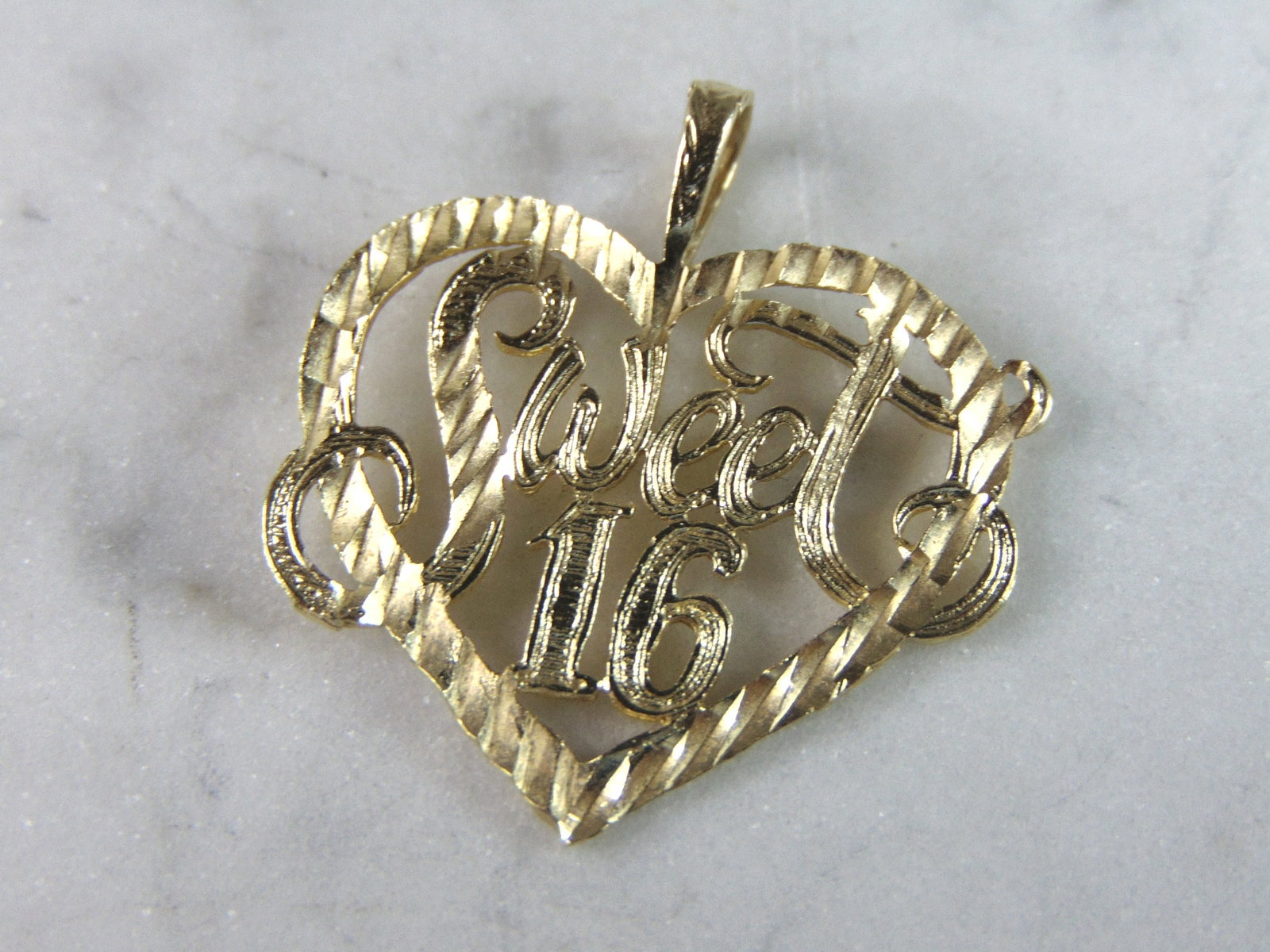 Womens Vintage Estate 14K Yellow Gold Sweet 16 Heart Pendant: A WOMEN'S VINTAGE ESTATE 14K YELLOW GOLD SWEEET 16 HEART PENDANT. PENDANT MEASURES 1" LONG BY 1" WIDE. TOTAL WEIGHT OF THE PENDANT IS 1.7g. WOULD MAKE A LOVELY GIFT FOR THAT SOMEONE SPECIAL. ANY QUEST
