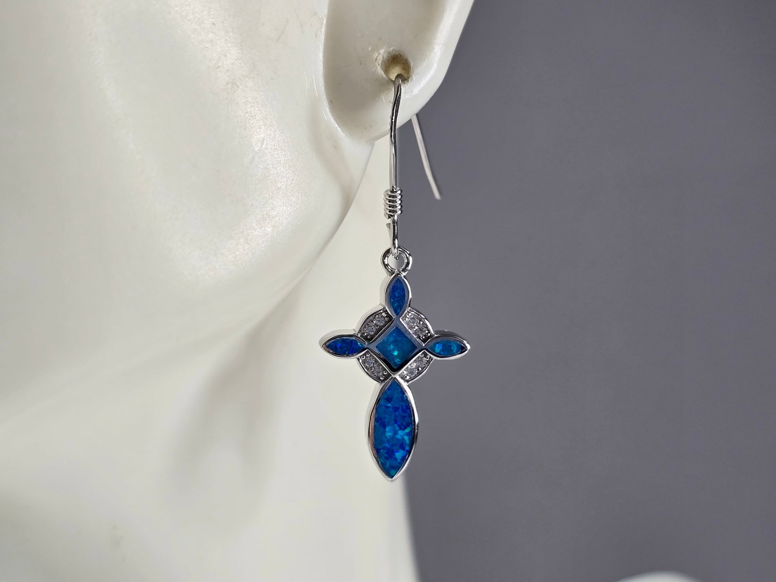 Womens Sterling Silver Blue Opal Cross Earrings: A PAIR OF WOMENS STERLING SILVER BLUE OPAL COLORED CROSS EARRINGS THAT WEIGH 3.3g AND MEASURES 1 1/4" LONG BY 1/2" WIDE. NOT SURE IF STONES ARE NATURAL OR MAN MADE. ANY QUESTIONS, PLEASE DO NOT HESITA