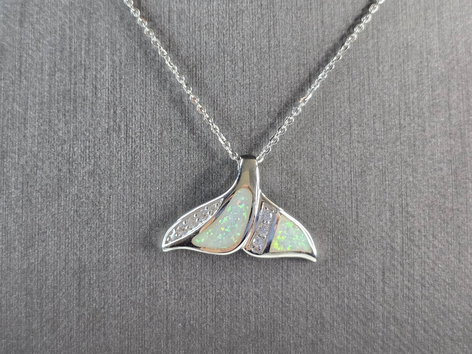 Womens Sterling Silver Opal Modernist Whale Tail Pendant Necklace: A WOMENS STERLING SILVER OPAL MODERNIST WHALE TAIL PENDANT. THE PENDANT WITH NECKLACE WEIGHS 5.0g. PENDANT MEASURES 1" LONG BY 1/2" WIDE, AND THE NECKLACE MEASURES 18" LONG, ADJUSTABLE TO 16". NOT SUR