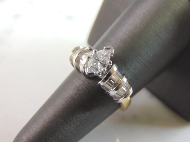 Womens 14K Yellow Gold Marquise Diamond Ring: A BEAUTIFUL WOMEN'S VINTAGE 14K GOLD ENGAGEMENT RING WITH A MARQUIS CUT DIAMOND THAT IS ABOUT .50cts, WITH A TOTAL OF ABOUT 1.0cts. THE SIZE OF THE RING IS A 7.0, AND WEIGHS 6.5g. THE COLOR IS ABOUT A